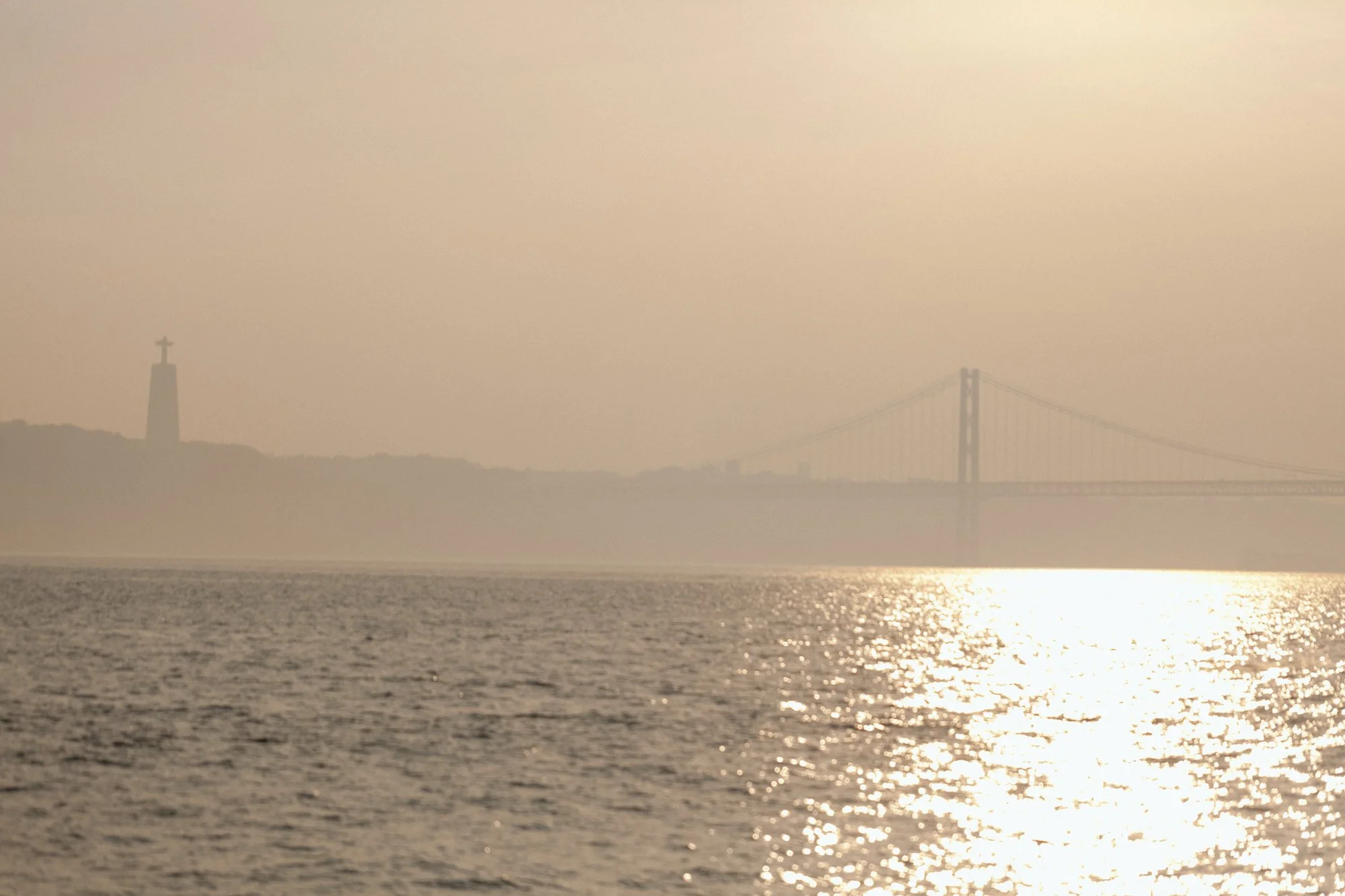 Soft sunset view over the Tagus River and 25 de Abril Bridge in Lisbon Portugal