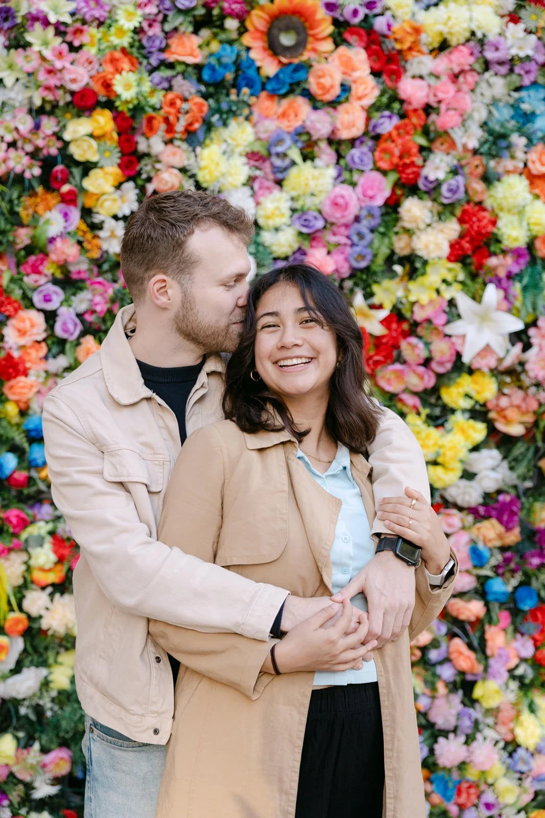 Couple sharing a kiss in front of the flower wall at Santo António Church Lisbon