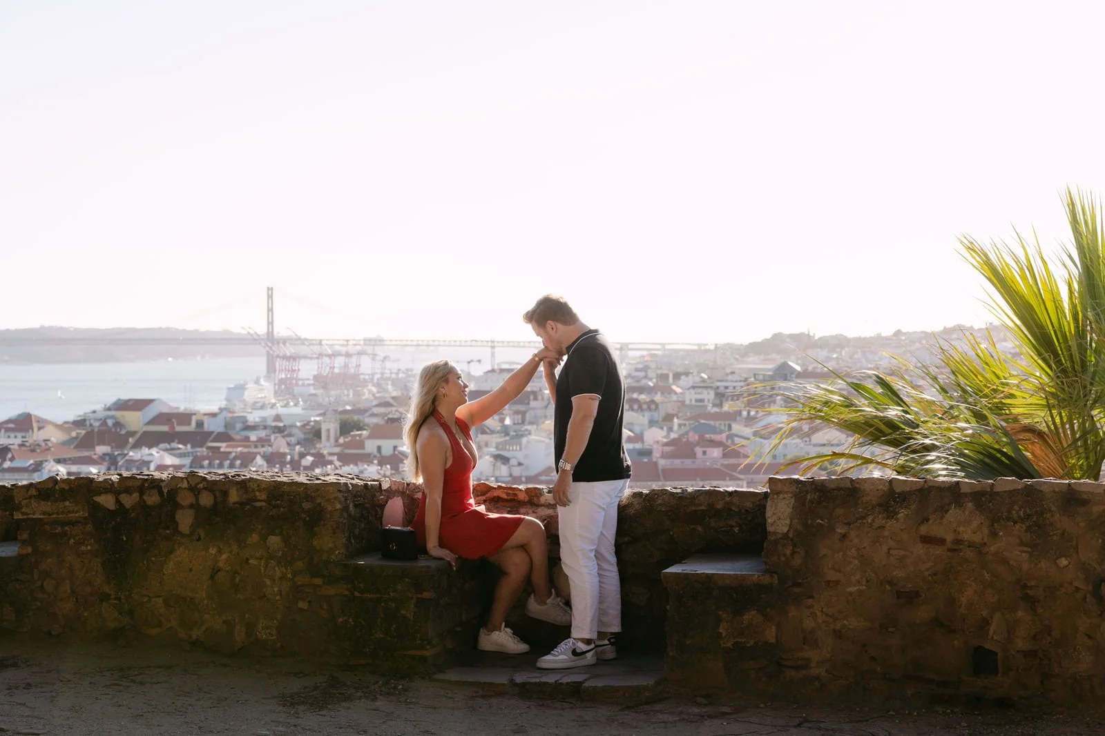 Couple enjoying Lisbon views from Castelo de São Jorge after getting engaged