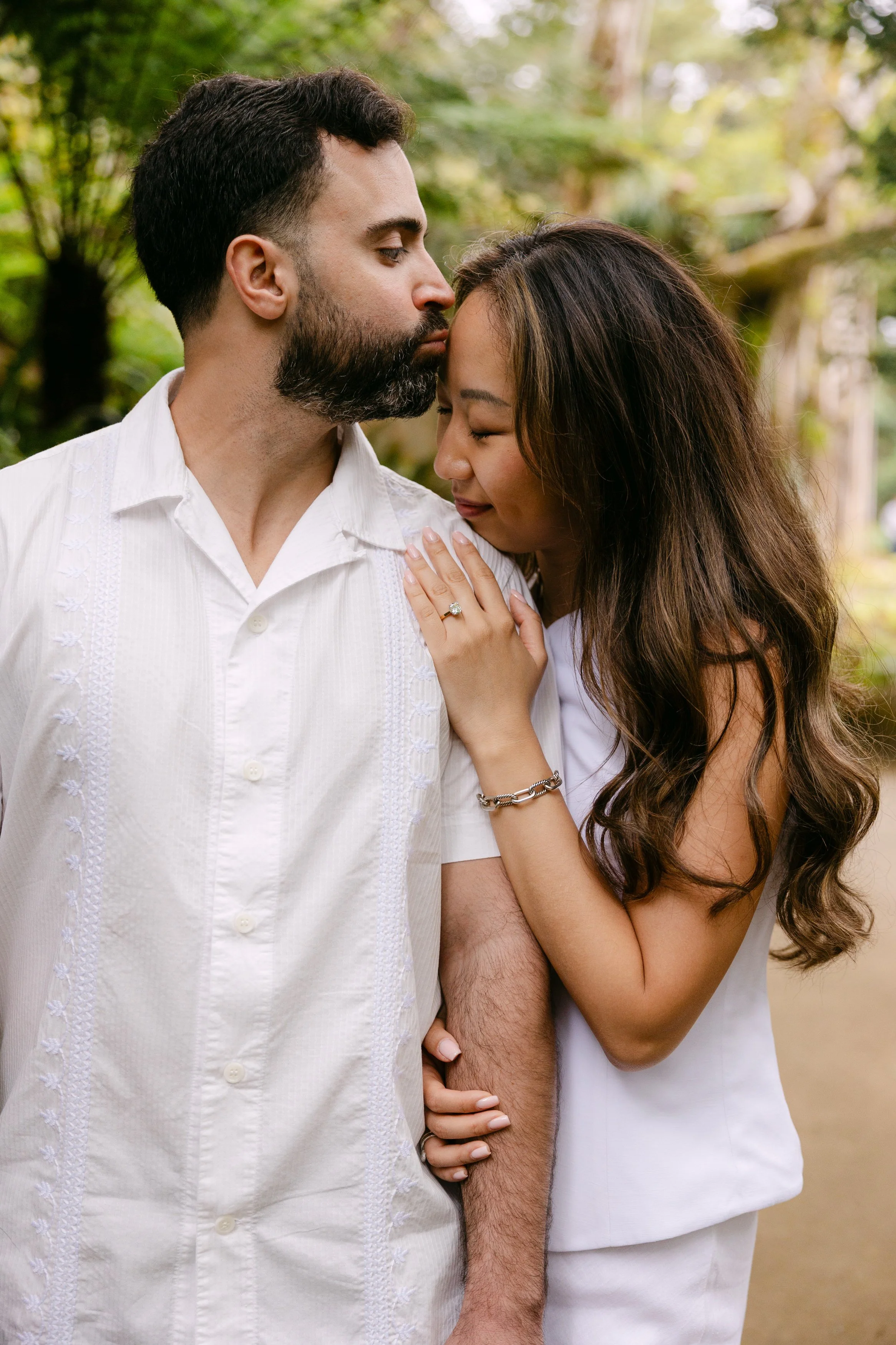 Close-up portrait of engaged couple showing engagement ring during proposal photoshoot in Sintra.