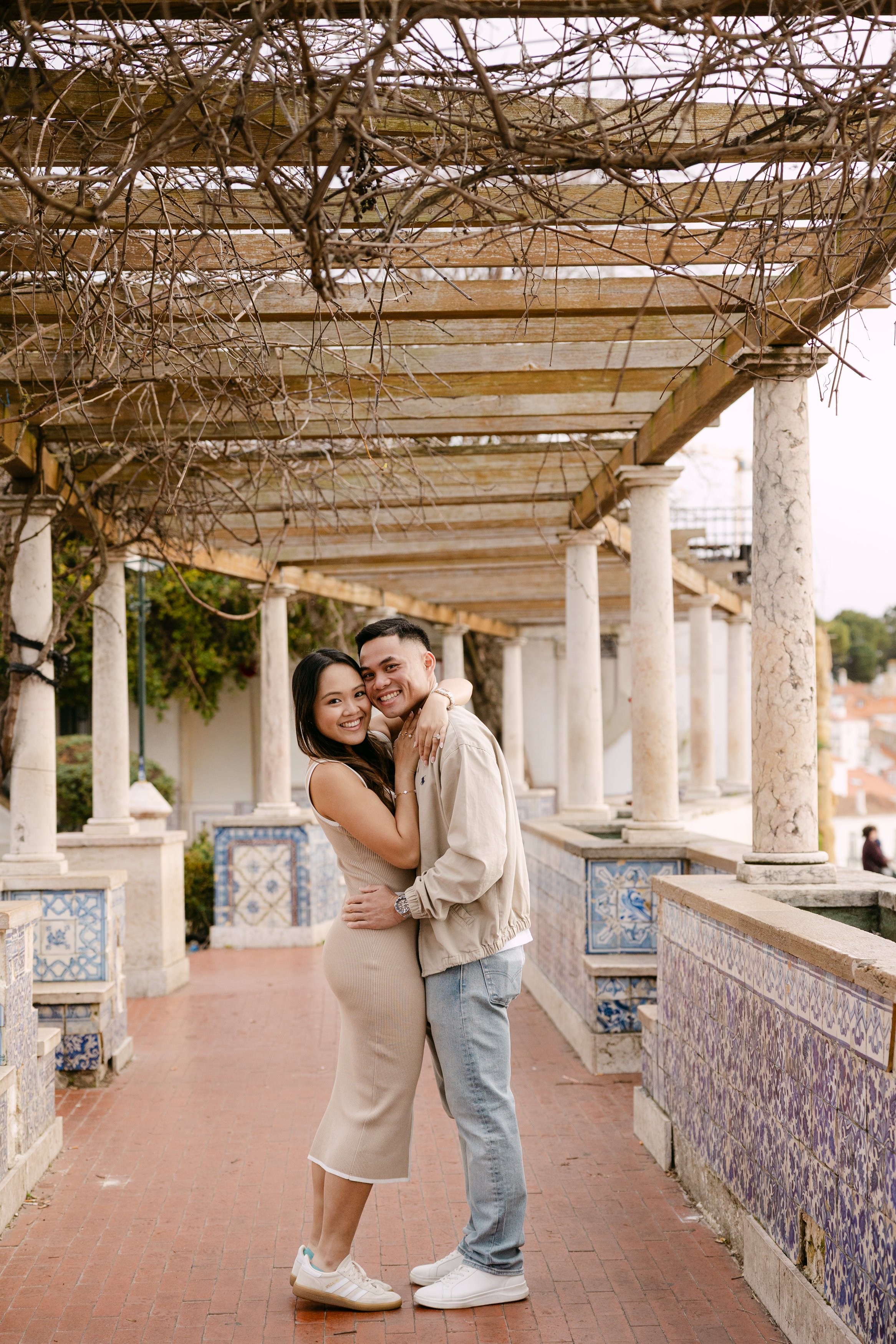 Engaged couple posing together in tiled walkway at Santa Luzia in Lisbon