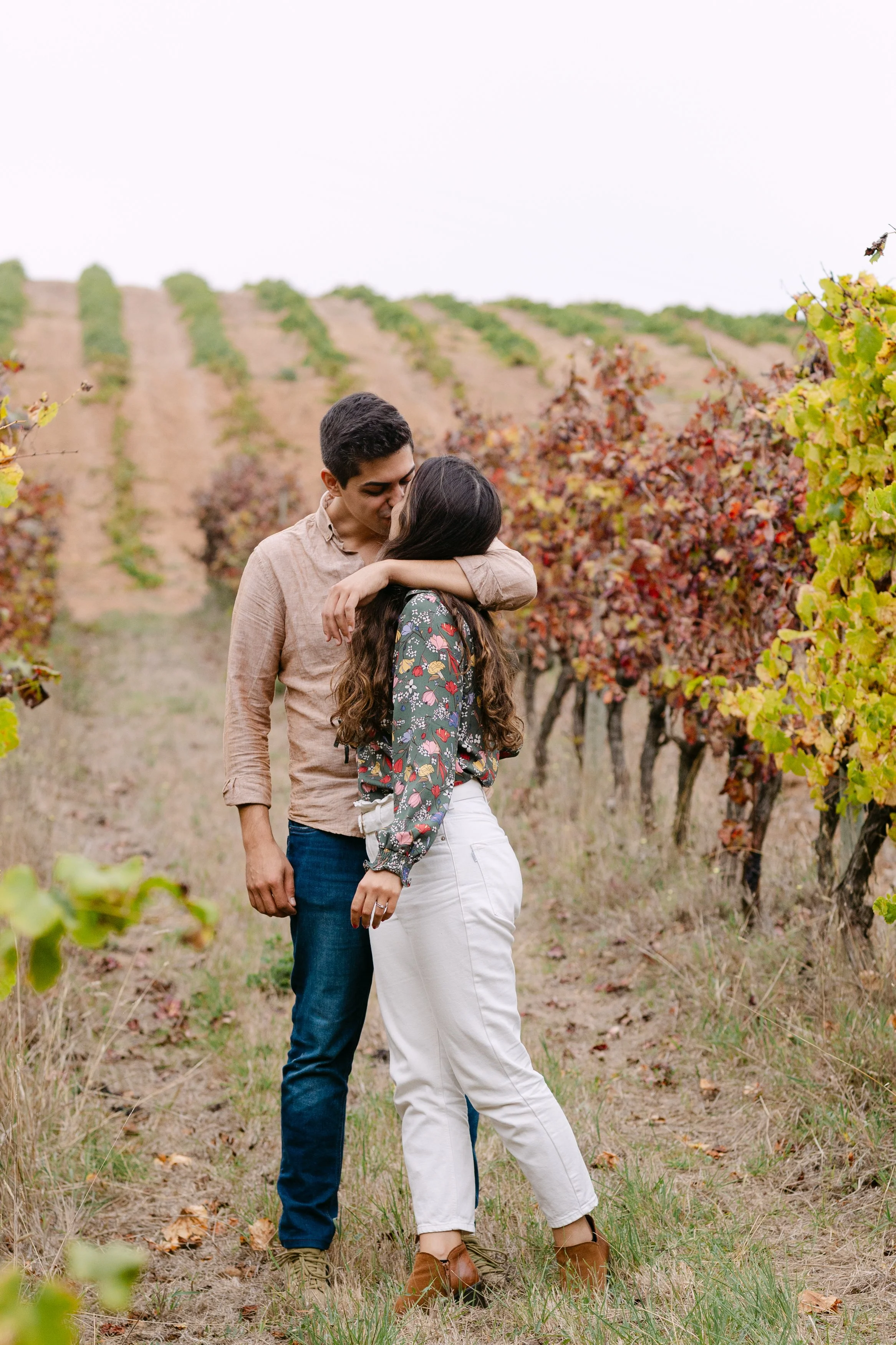 Couple embracing in the vineyards after surprise proposal at Quinta de Santana