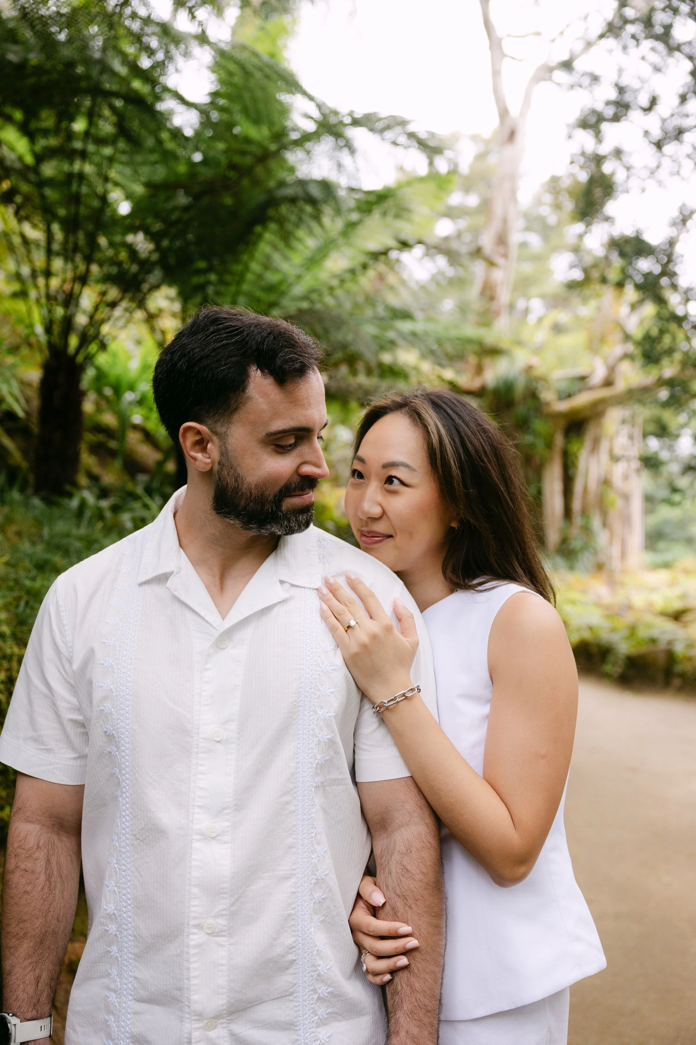 Engaged couple walking through the gardens of Monserrate during a romantic couple session in Sintra.