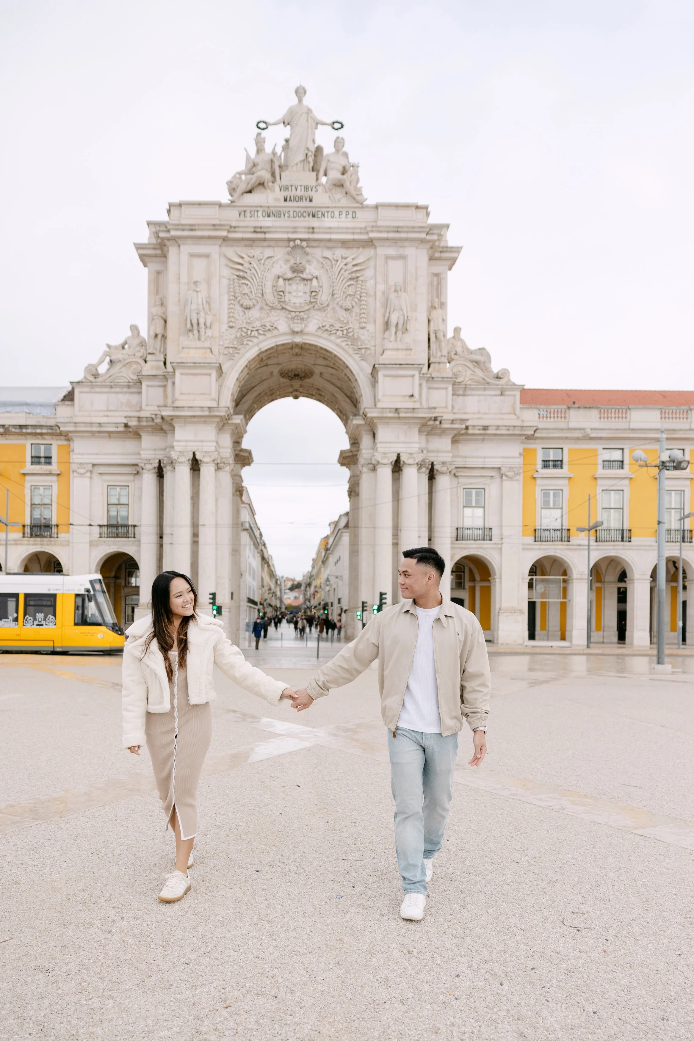 Couple walking together at Terreiro do Paço during Lisbon engagement session