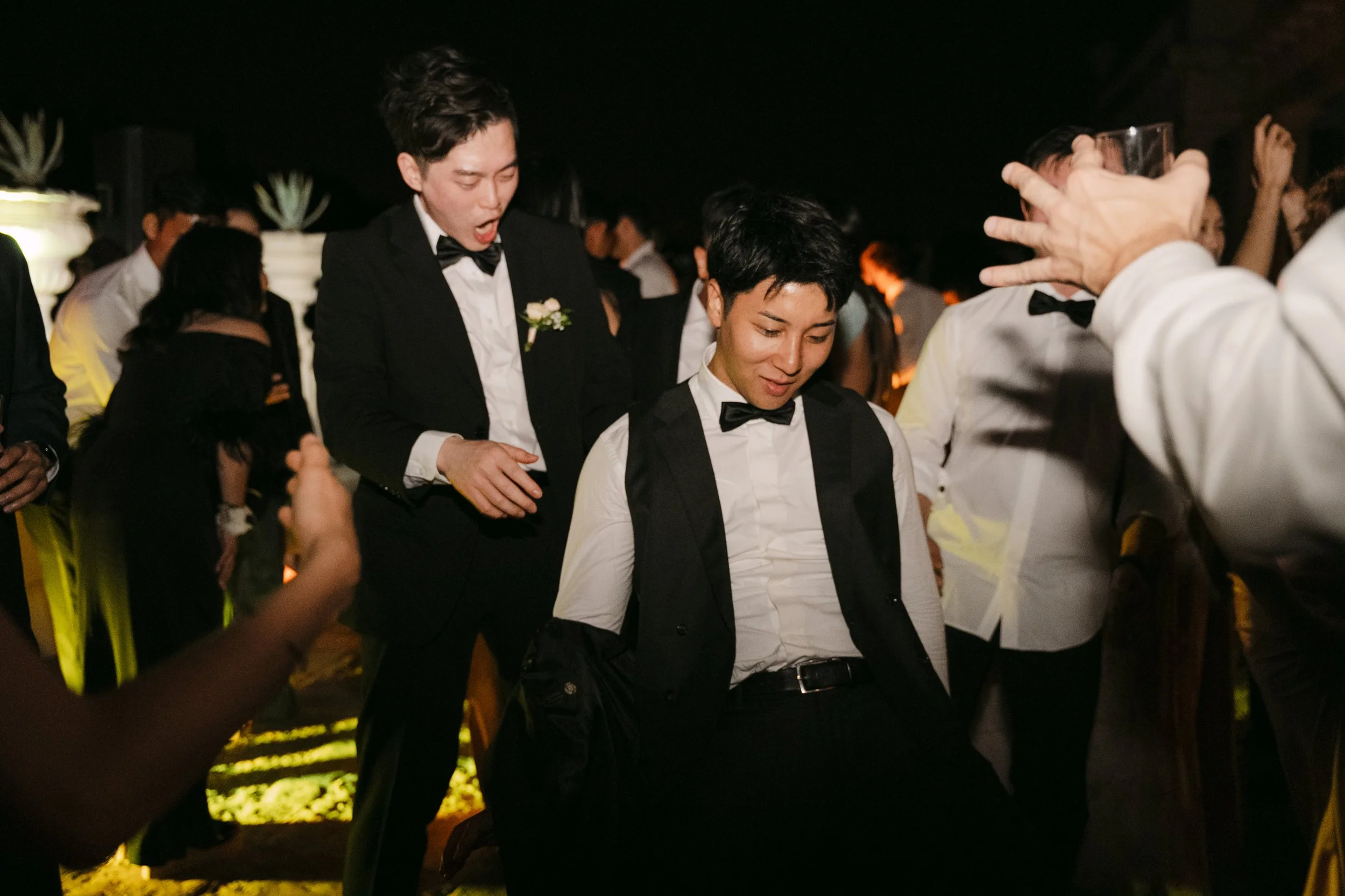 Wedding guests dancing together during the nighttime party at Palácio Nacional de Queluz.
