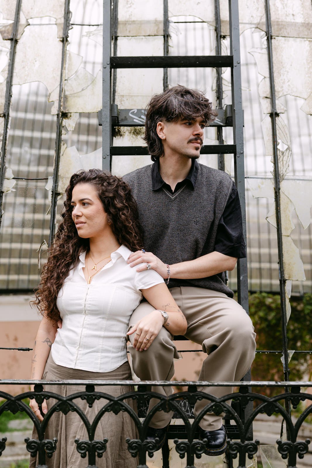 Engaged couple posing beside the abandoned greenhouse at Tapada das Necessidades in Lisbon