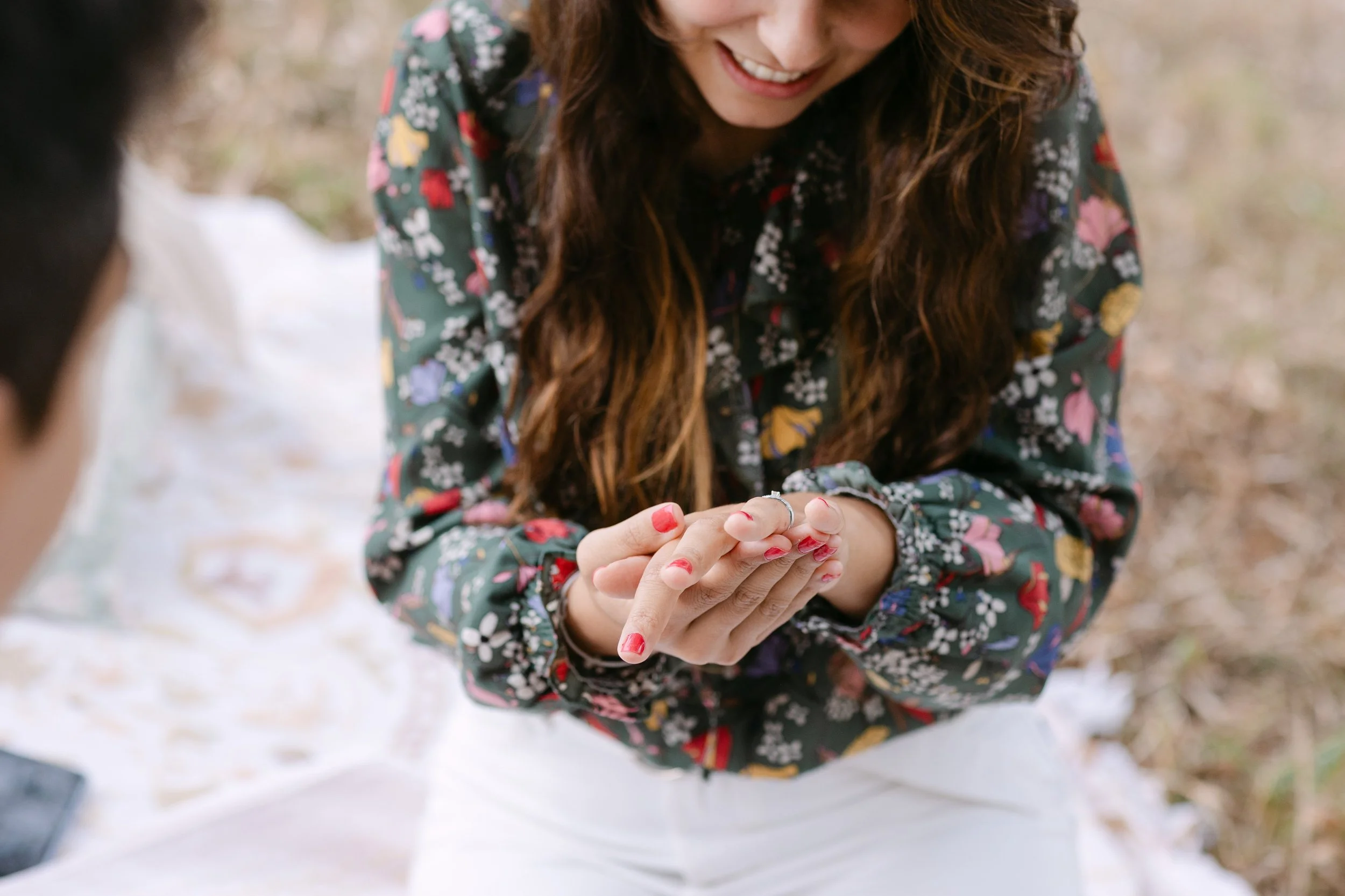 girl smiling while admiring engagement ring after vineyard proposal in Portugal