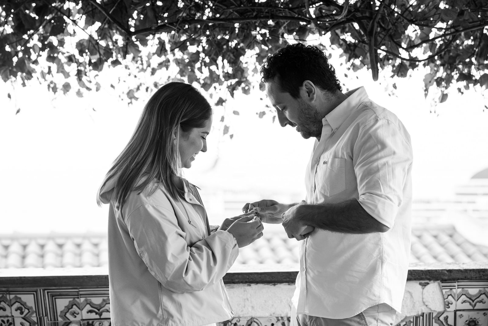 Couple admiring a two-stone engagement ring after a proposal in Lisbon, Portugal