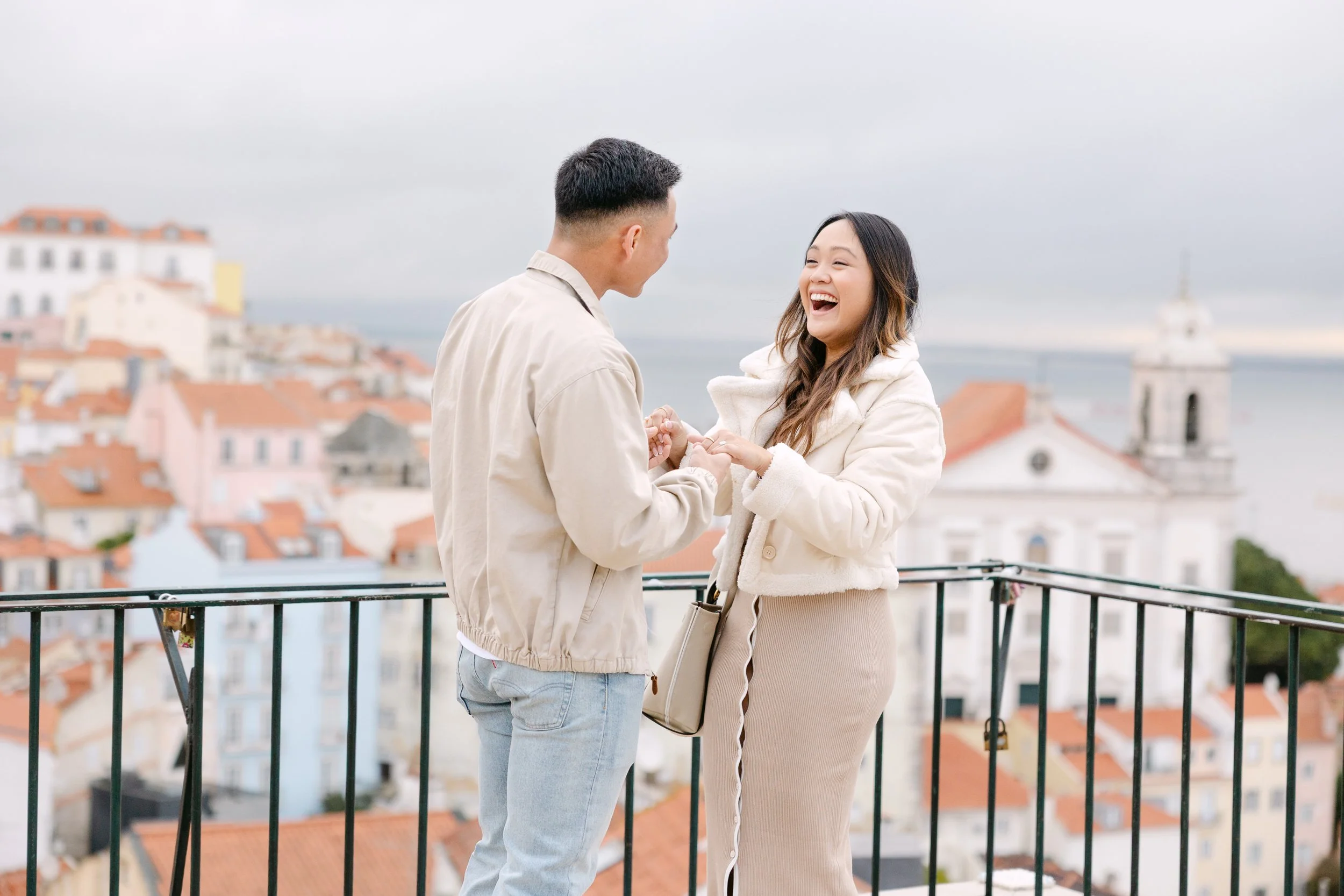 Couple laughing together after surprise proposal in Alfama Lisbon