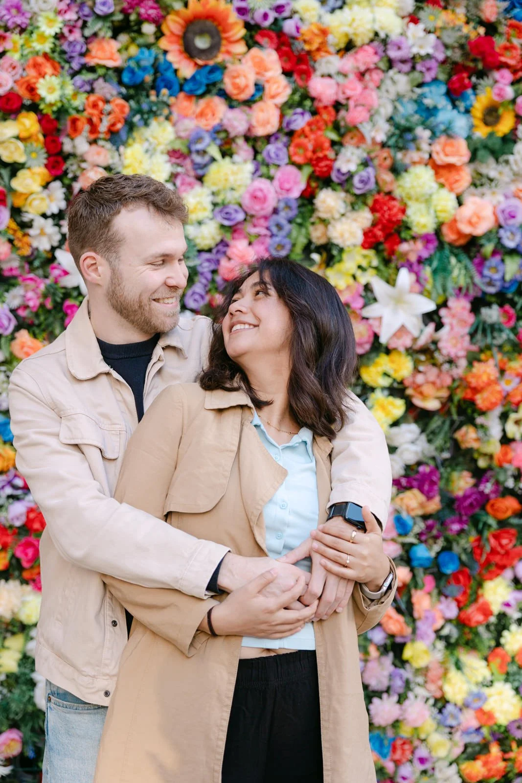 Couple celebrating their engagement in Lisbon surrounded by colourful flowers
