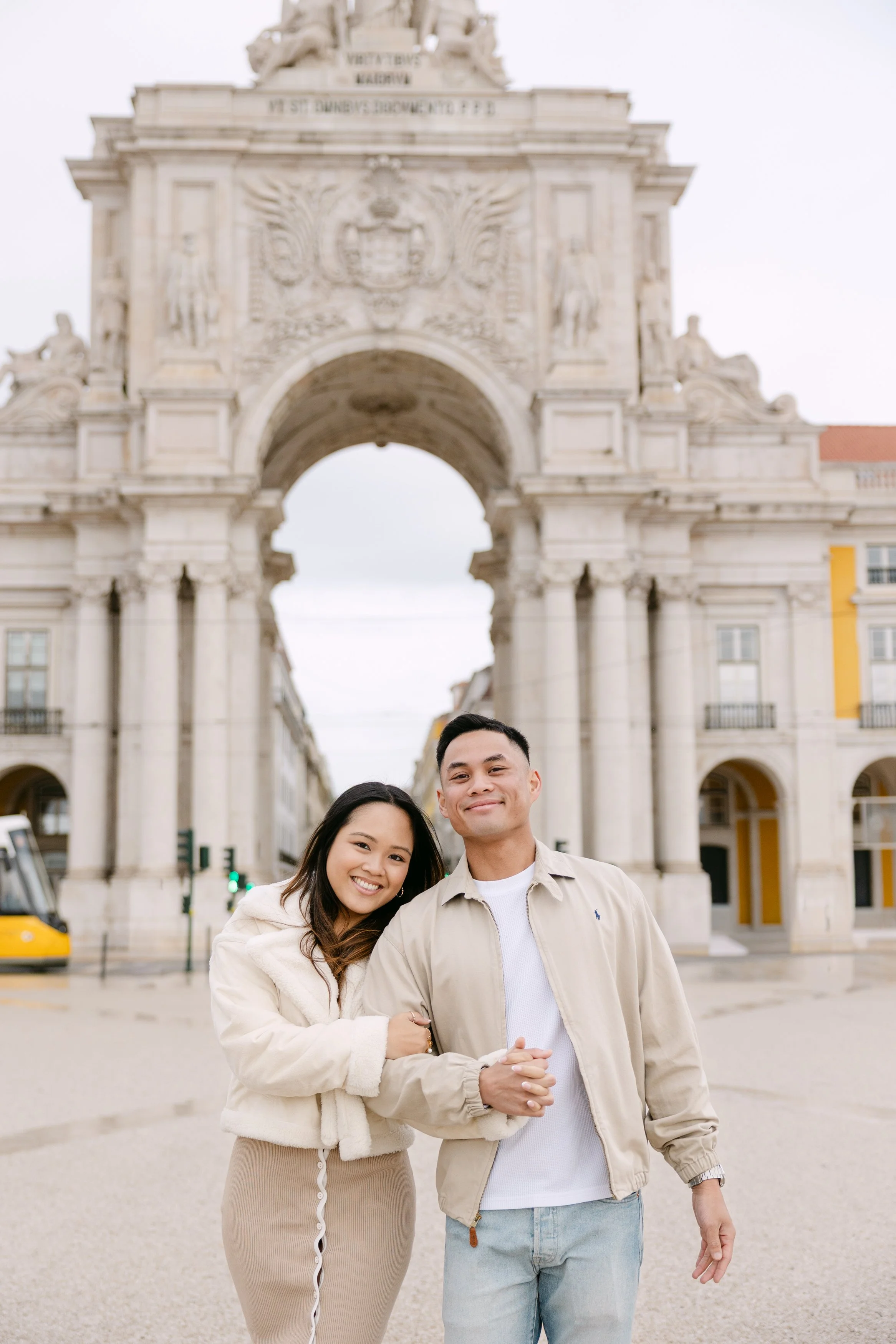 Romantic portrait of engaged couple at Praça do Comércio in Lisbon Portugal
