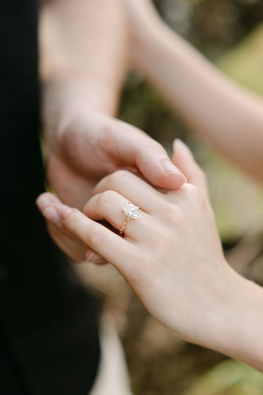 Close-up of a newly engaged woman’s hand showing her engagement ring after a surprise proposal in Portugal.