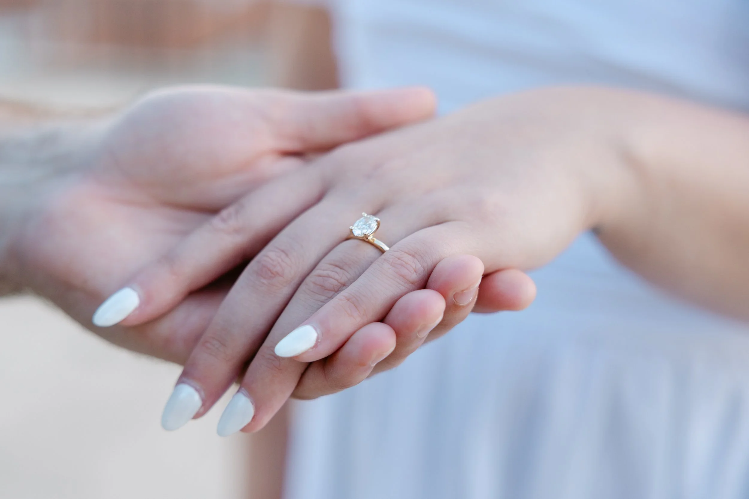 Close-up of Emily's engagement ring after a surprise proposal at Portas do Sol in Lisbon.