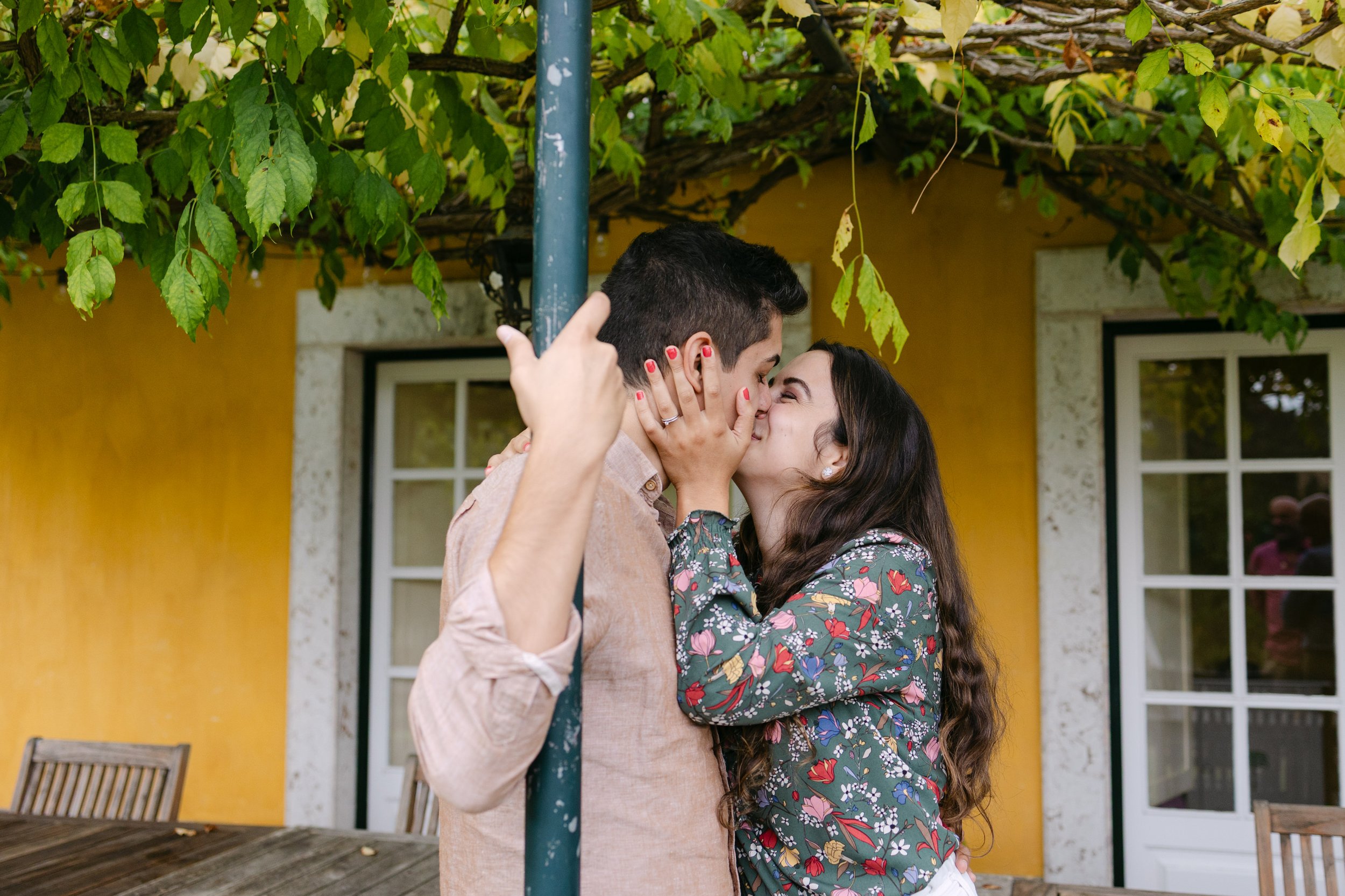 Recently engaged couple kissing after romantic vineyard proposal in Portugal