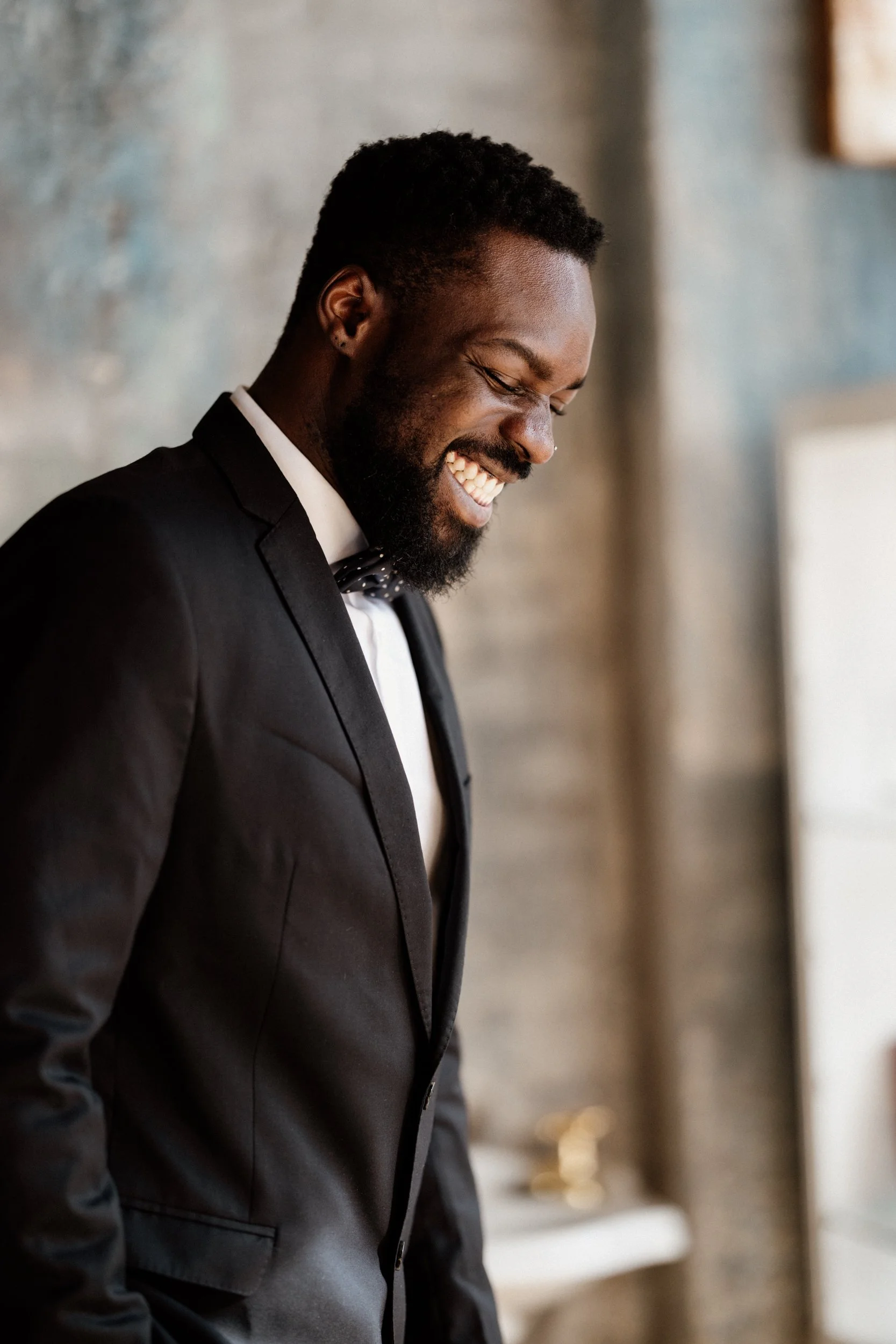 Groom portrait wearing black tuxedo at luxury wedding