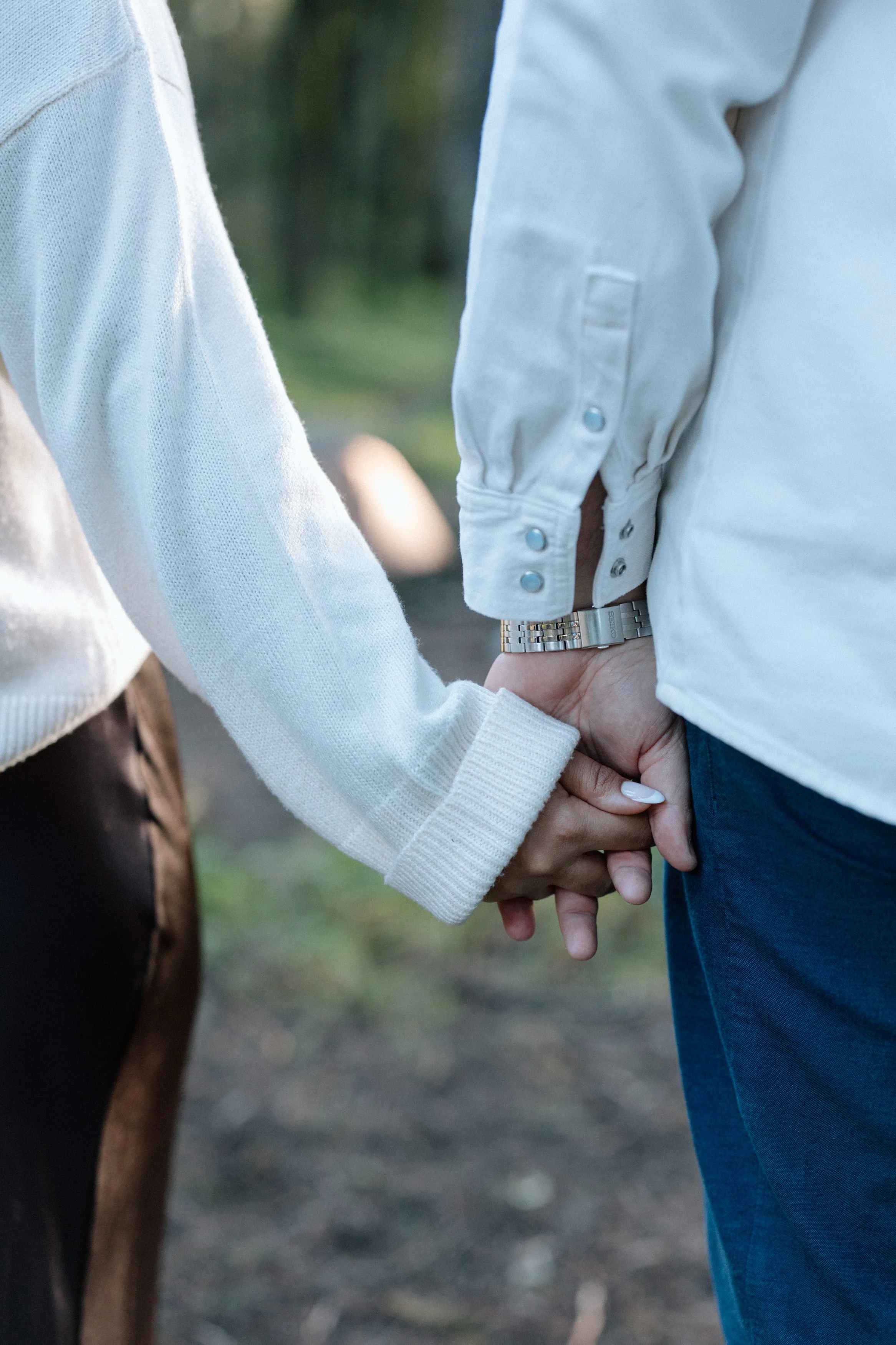 Close-up detail photo of couple holding hands during engagement session