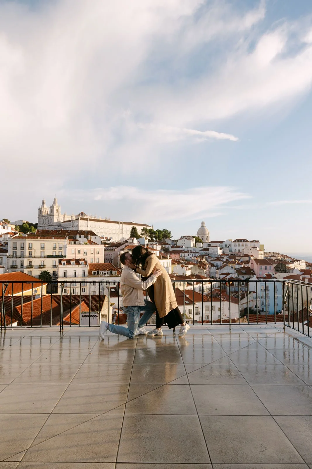 Couple celebrating their engagement at Miradouro das Portas do Sol in Lisbon