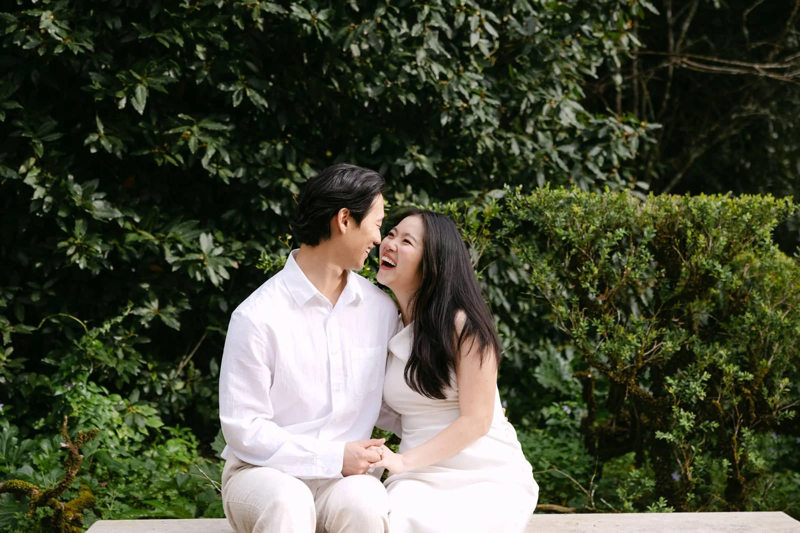 Candid engagement photo of couple laughing together at Palácio de Queluz.
