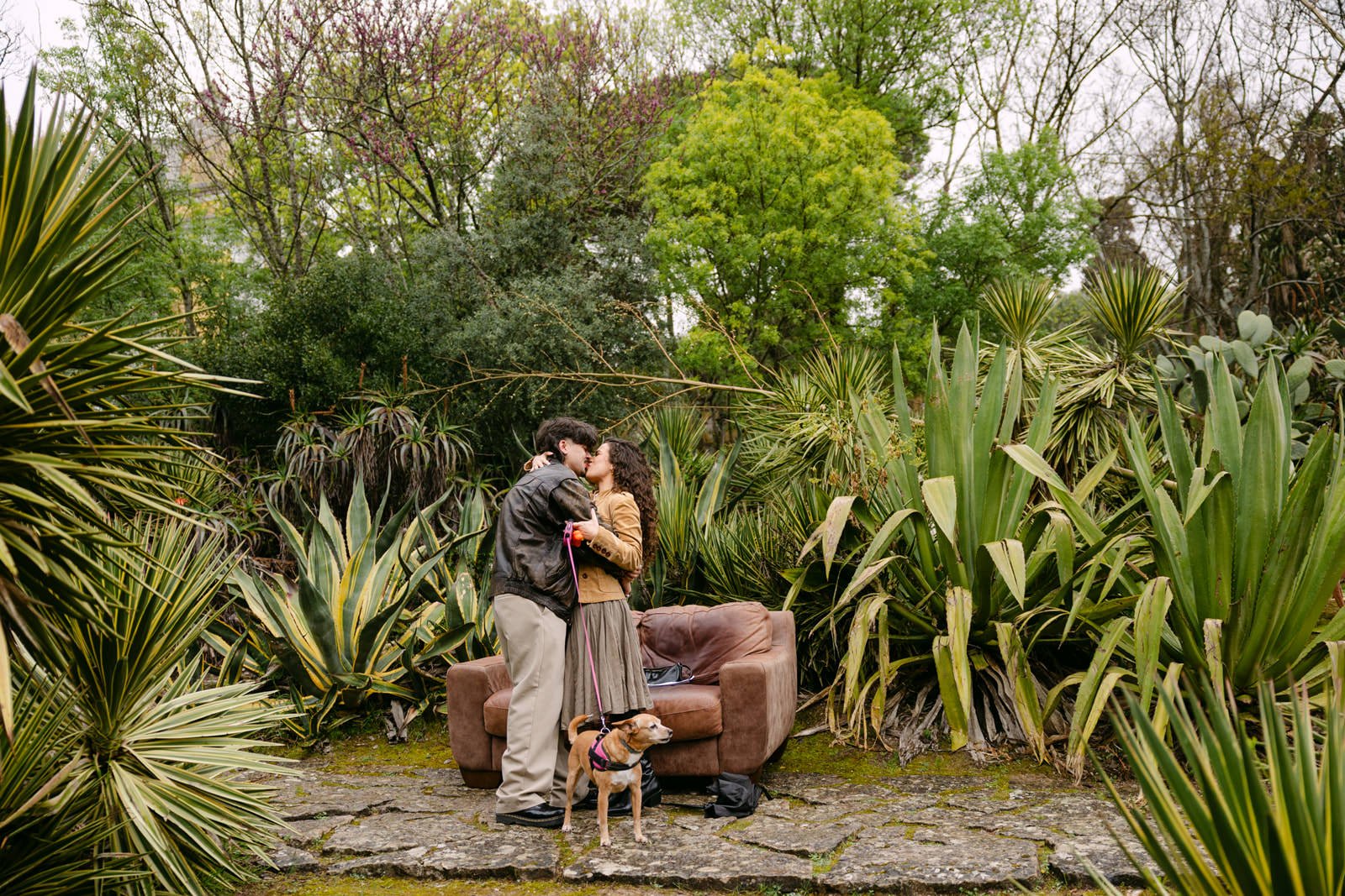 Couple kissing after a surprise proposal at Tapada das Necessidades