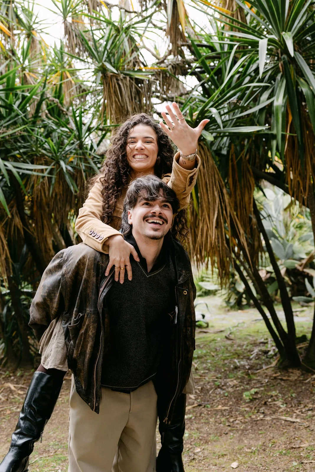 Newly engaged couple celebrating their proposal and showing the engagement ring in Lisbon