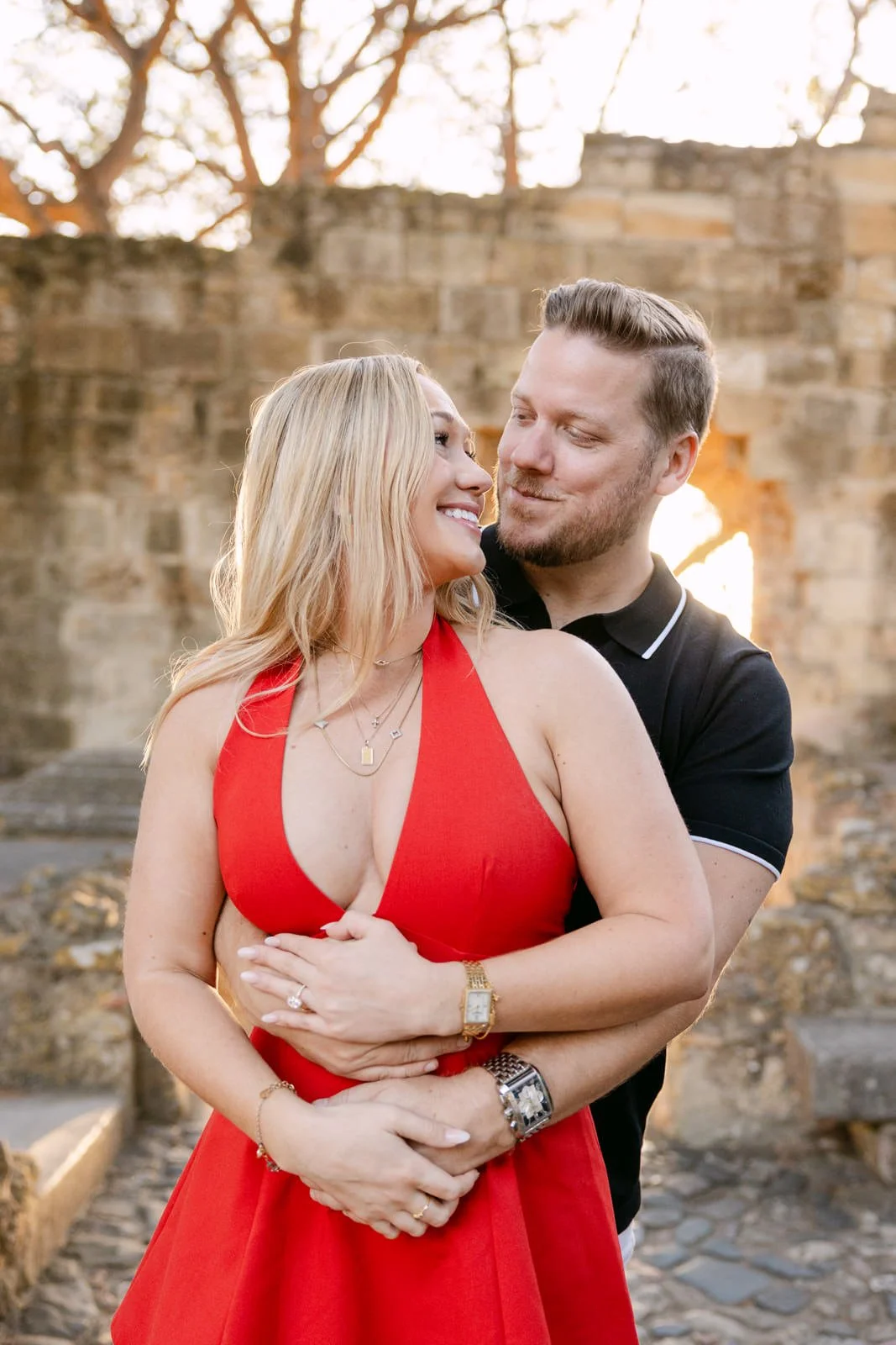 Couple celebrating their engagement at Castelo de São Jorge in Lisbon, Portugal