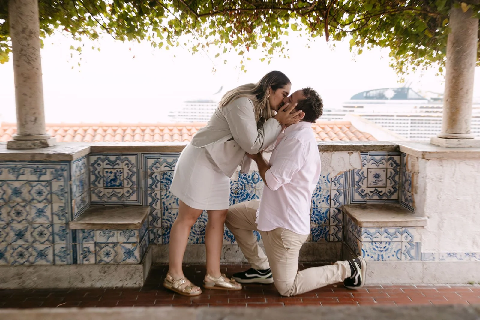 Emotional proposal reaction photographed at Miradouro de Santa Luzia in Lisbon