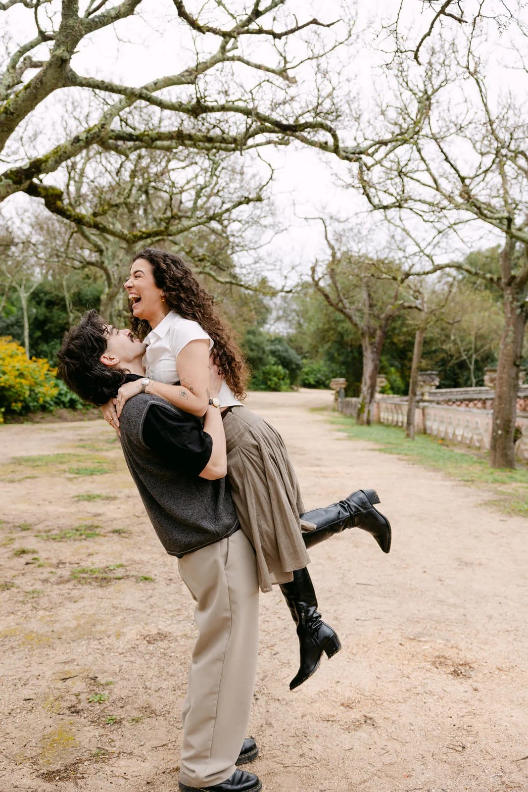 Couple laughing together during an engagement session at Tapada das Necessidades