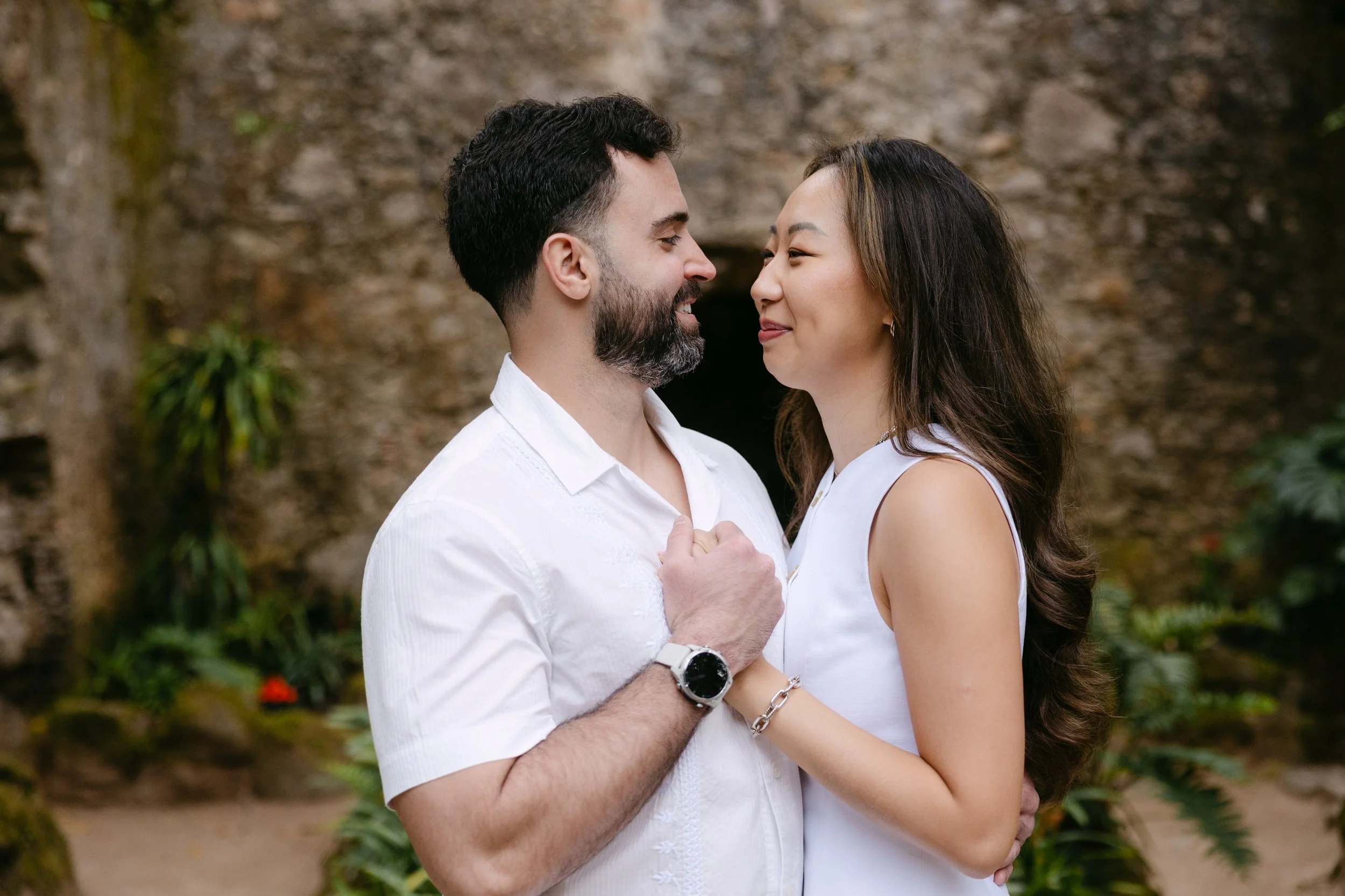 Couple celebrating their engagement at Monserrate ruins surrounded by lush greenery in Sintra.