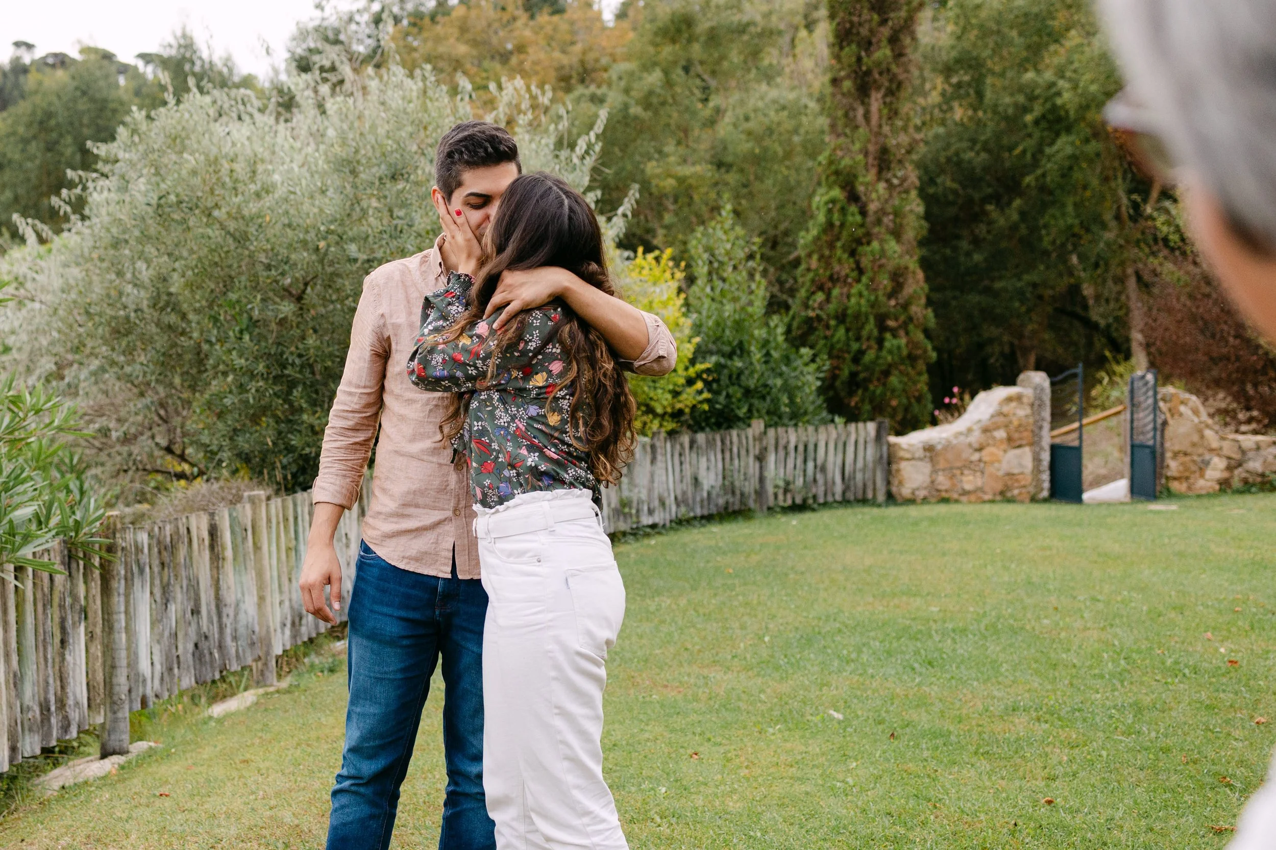 Recently engaged couple hugging emotionally after surprise proposal in Portugal
