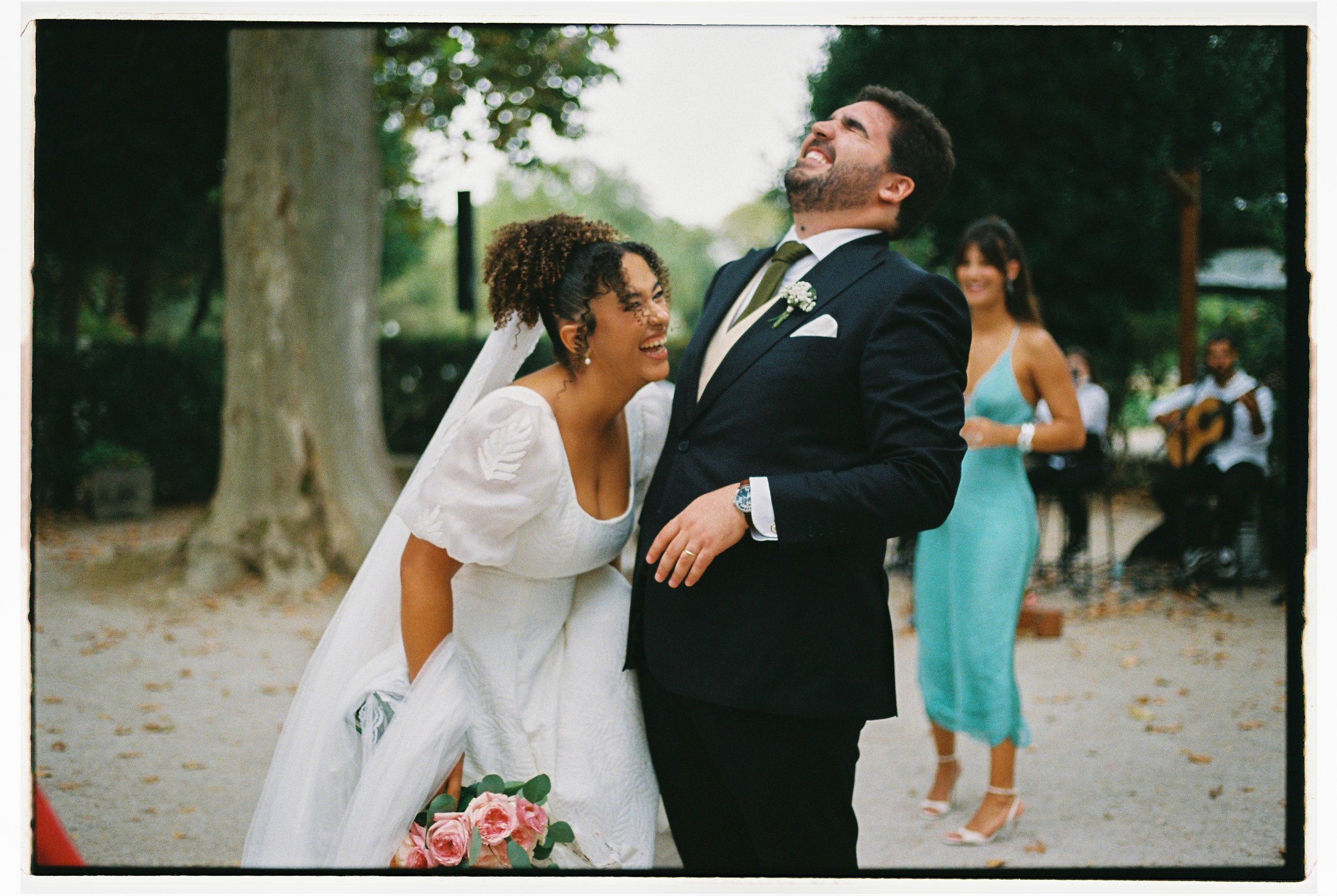 Newlywed couple laughing together photographed in documentary wedding photography style 35mm film in Portugal