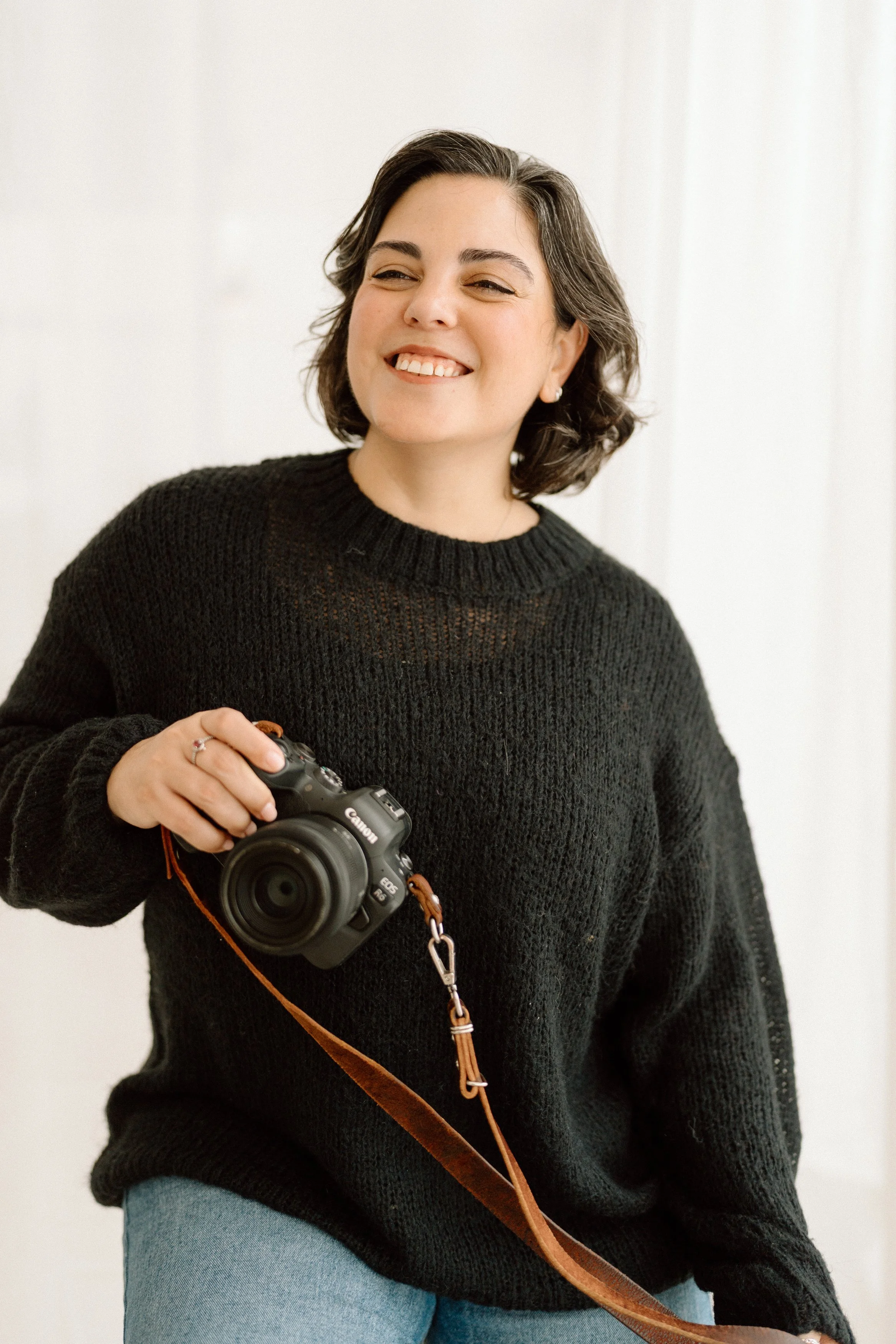 Nia Carvalho Portugal documentary wedding photographer holding camera