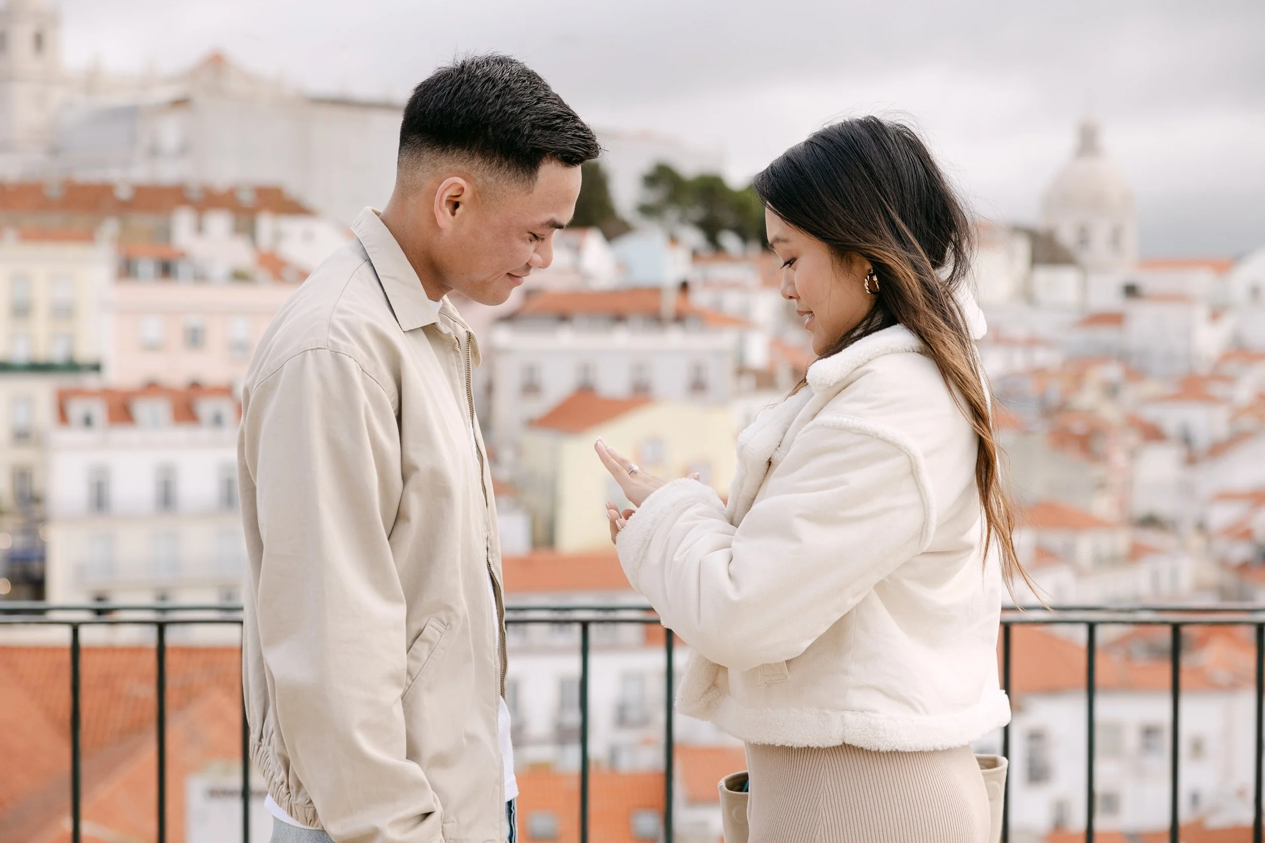 Bride-to-be looking at engagement ring after surprise proposal in Lisbon