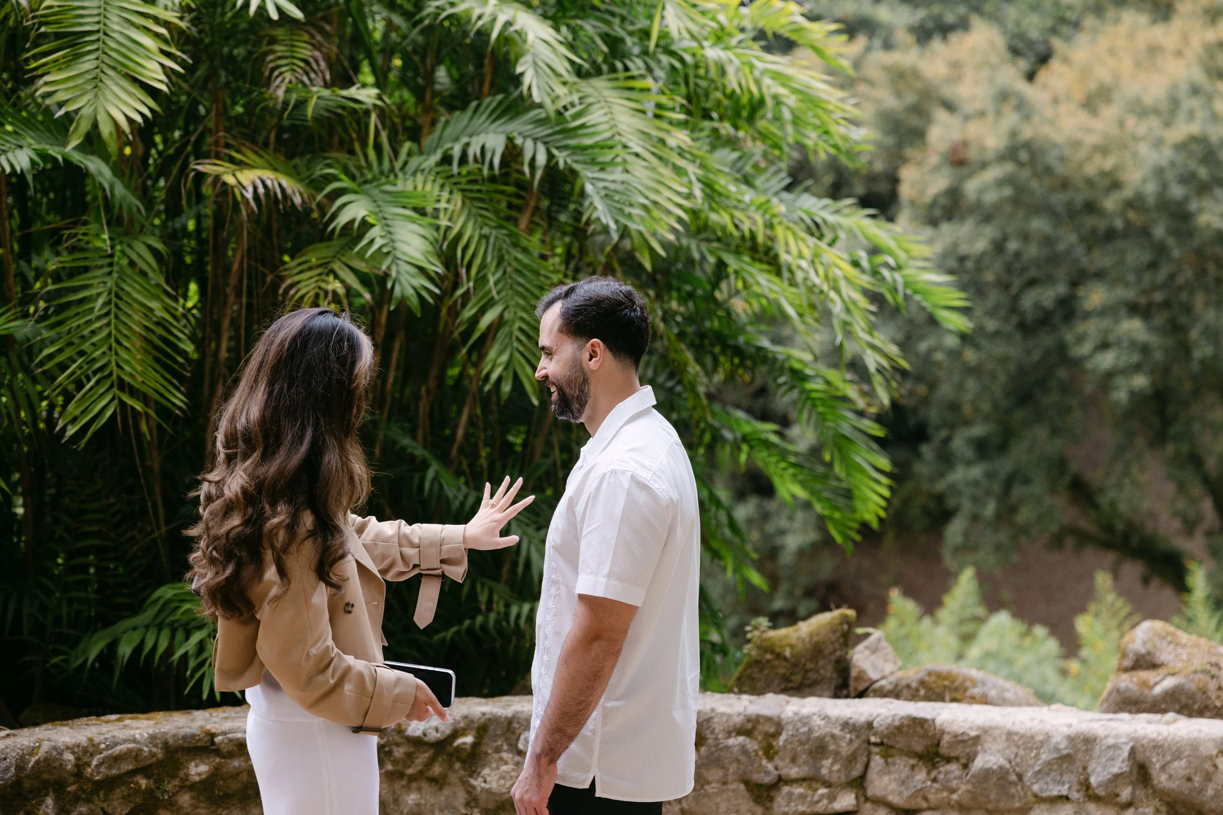 Emotional reaction moments after a surprise proposal at Monserrate Palace ruins in Sintra.