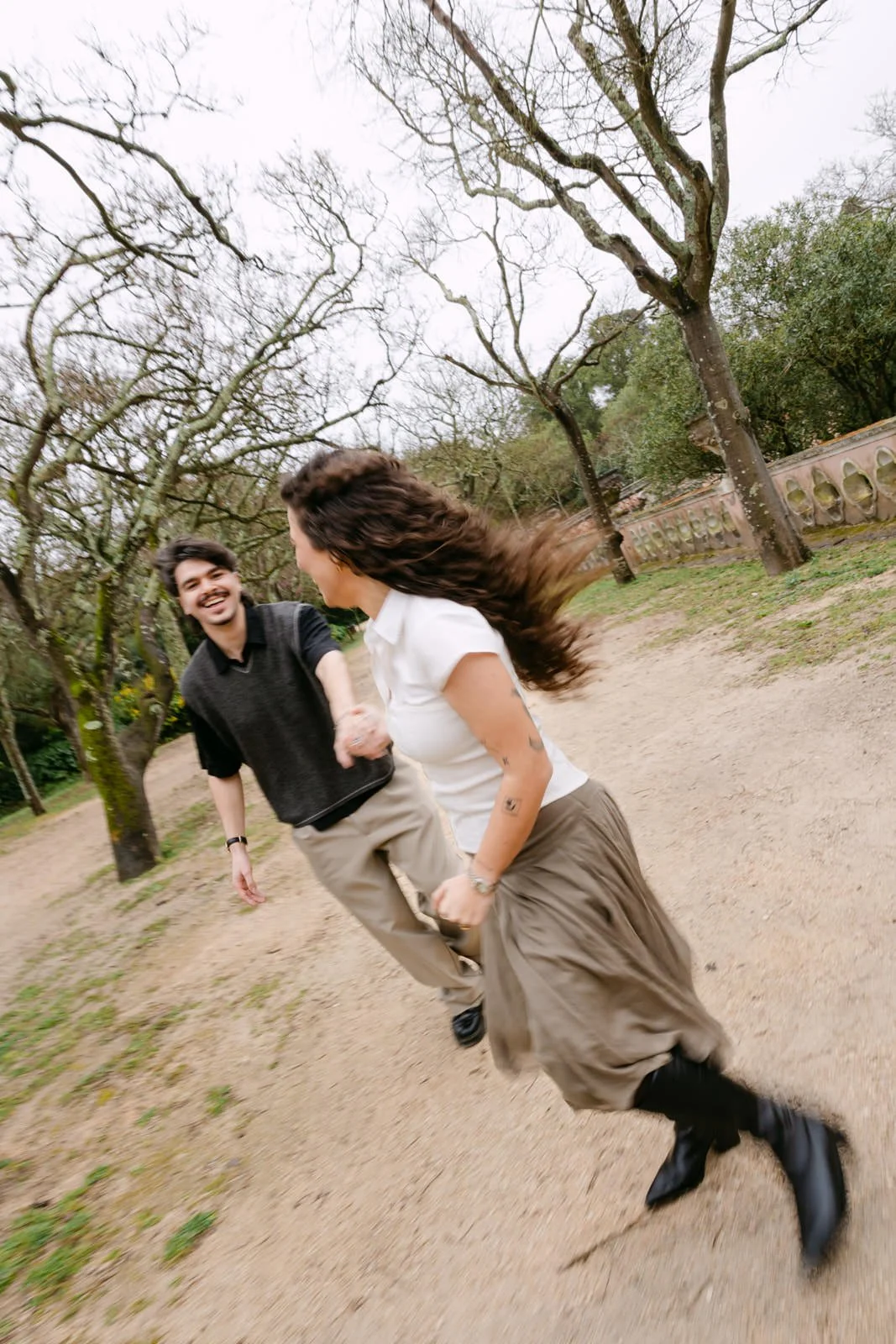 Candid engagement photography at Tapada das Necessidades gardens in Lisbon