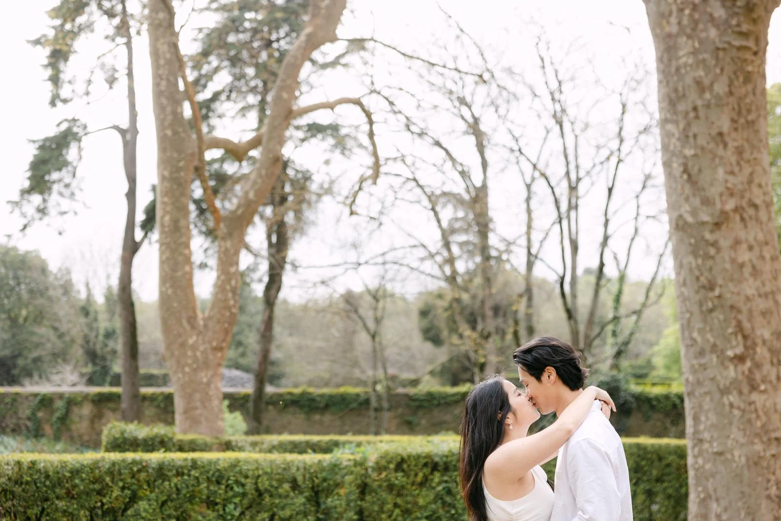 Close-up portrait of engaged couple kissing during photoshoot at Palácio de Queluz.