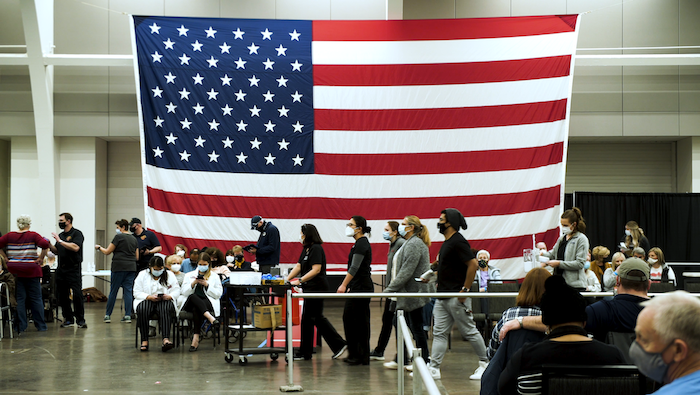 A vaccine distribution site in West Virgina with the American flag in the background 