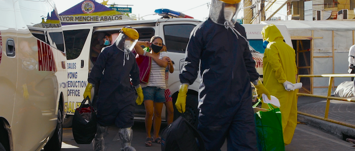 Philippine government officials help a family that has been exposed to the novel Covid-19 virus