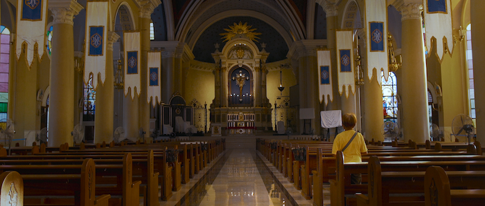 A Filipina woman prays in a church that is totally abandoned because of the strict Covid-19 lockdown in Manila, Philippines 