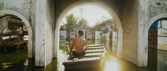Filipino paddling on a boat in an underwater village