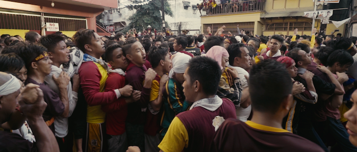 Celebration of Black Nazarene with men pushing each other to get close to the holy statue