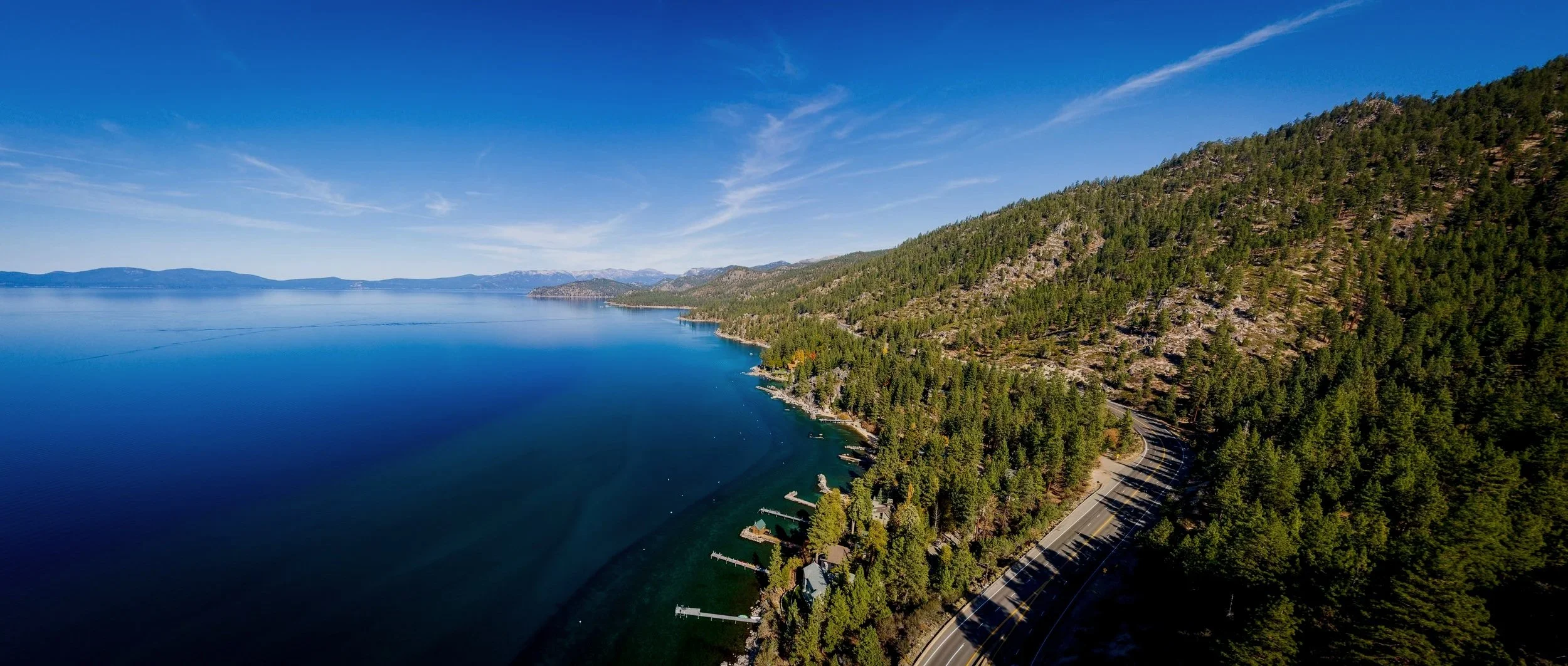 aerial-view-of-lake-tahoe-shoreline-with-mountains-2026-01-06-10-56-33-utc.jpg