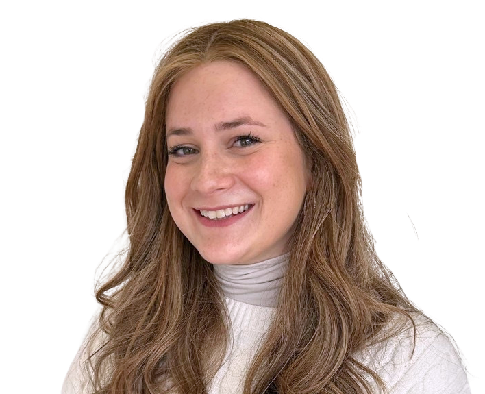 A smiling woman with long reddish-brown hair, wearing a white turtleneck sweater, against a white background.