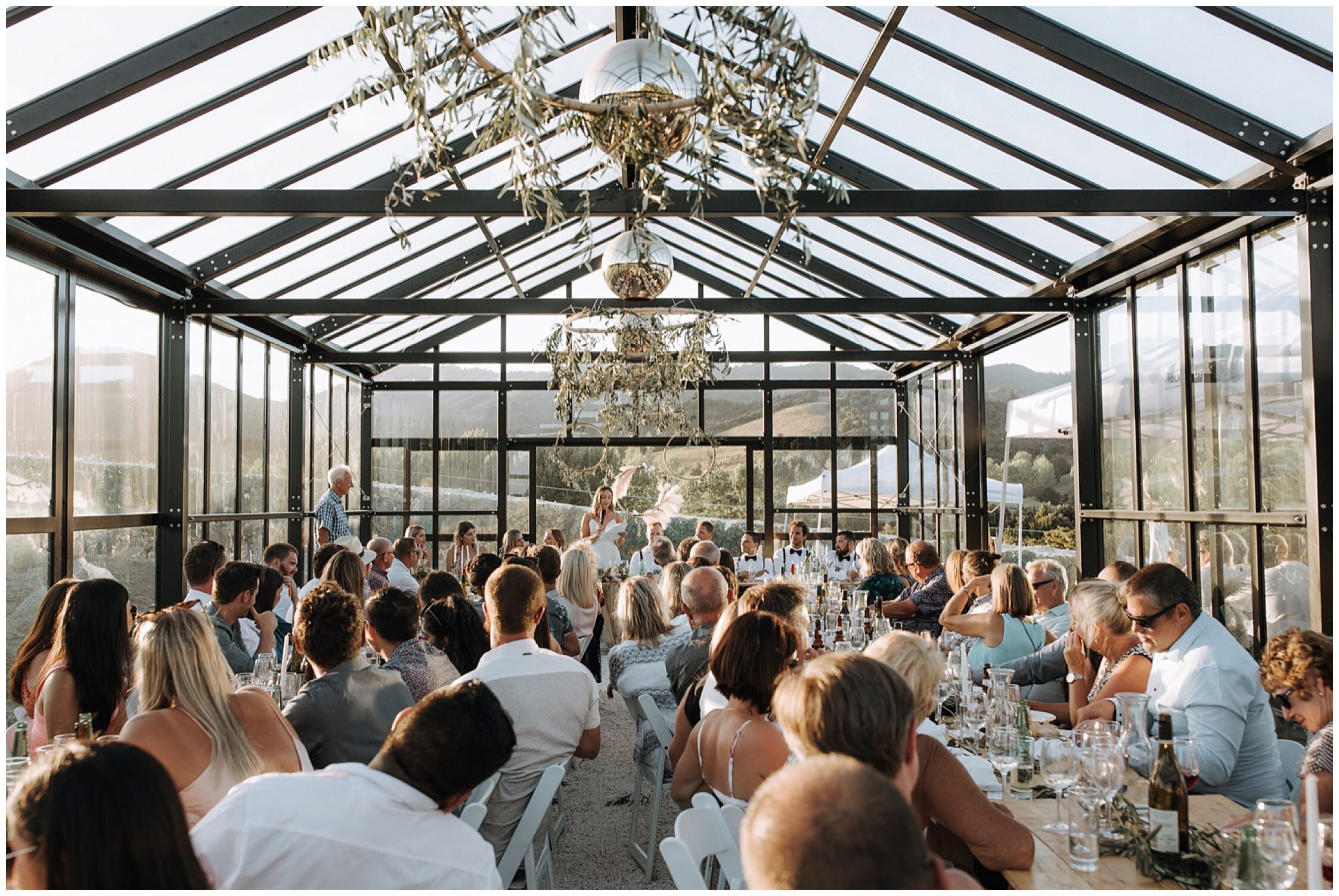 Zanda+Auckland+wedding+photographer+boho+retro+suspenders+groom+denim+jacket+bride+Te+Whai+Bay+Wines+venue+bright+glass+house+vineyard+photoshoot+New+Zealand_34.jpeg