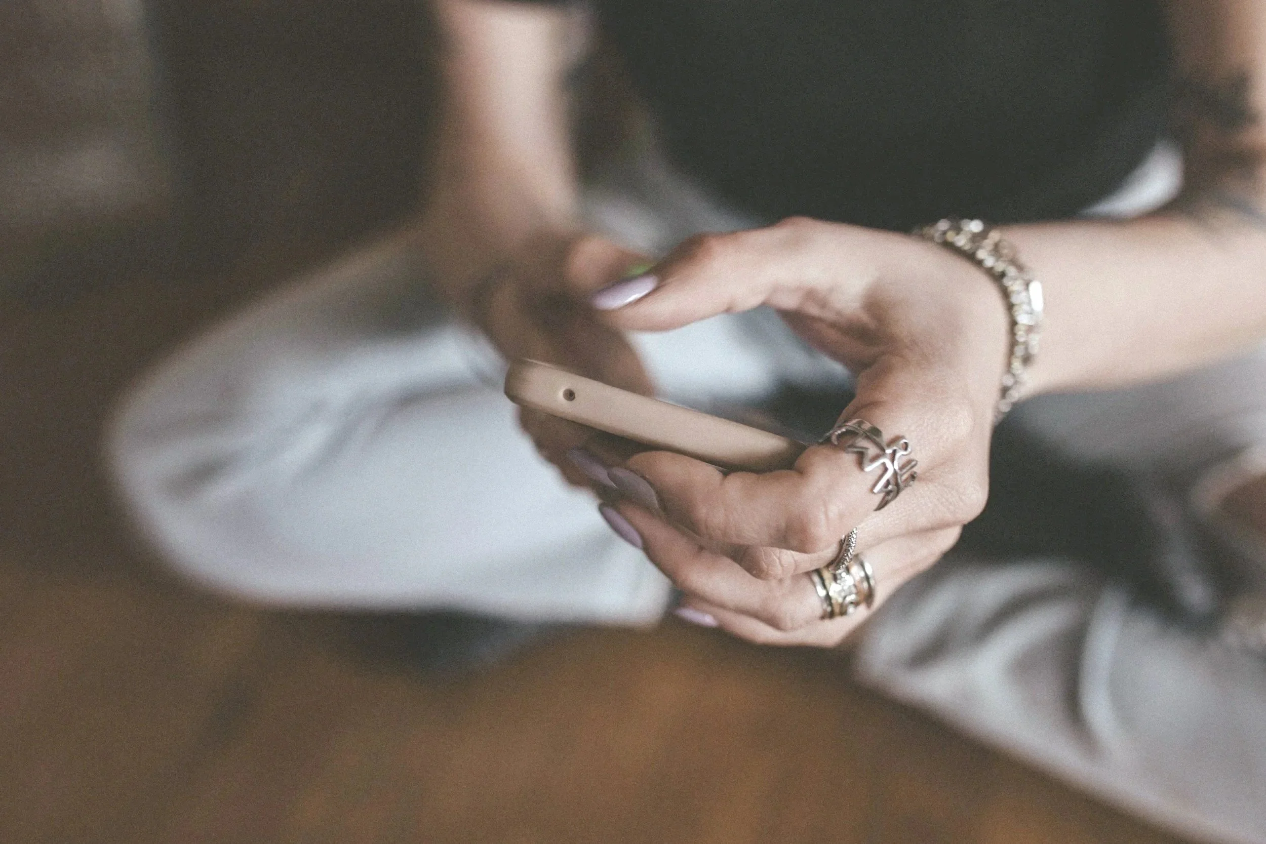 Female hands holding a cell phone and texting with Miss Jen Potty Training Consultant