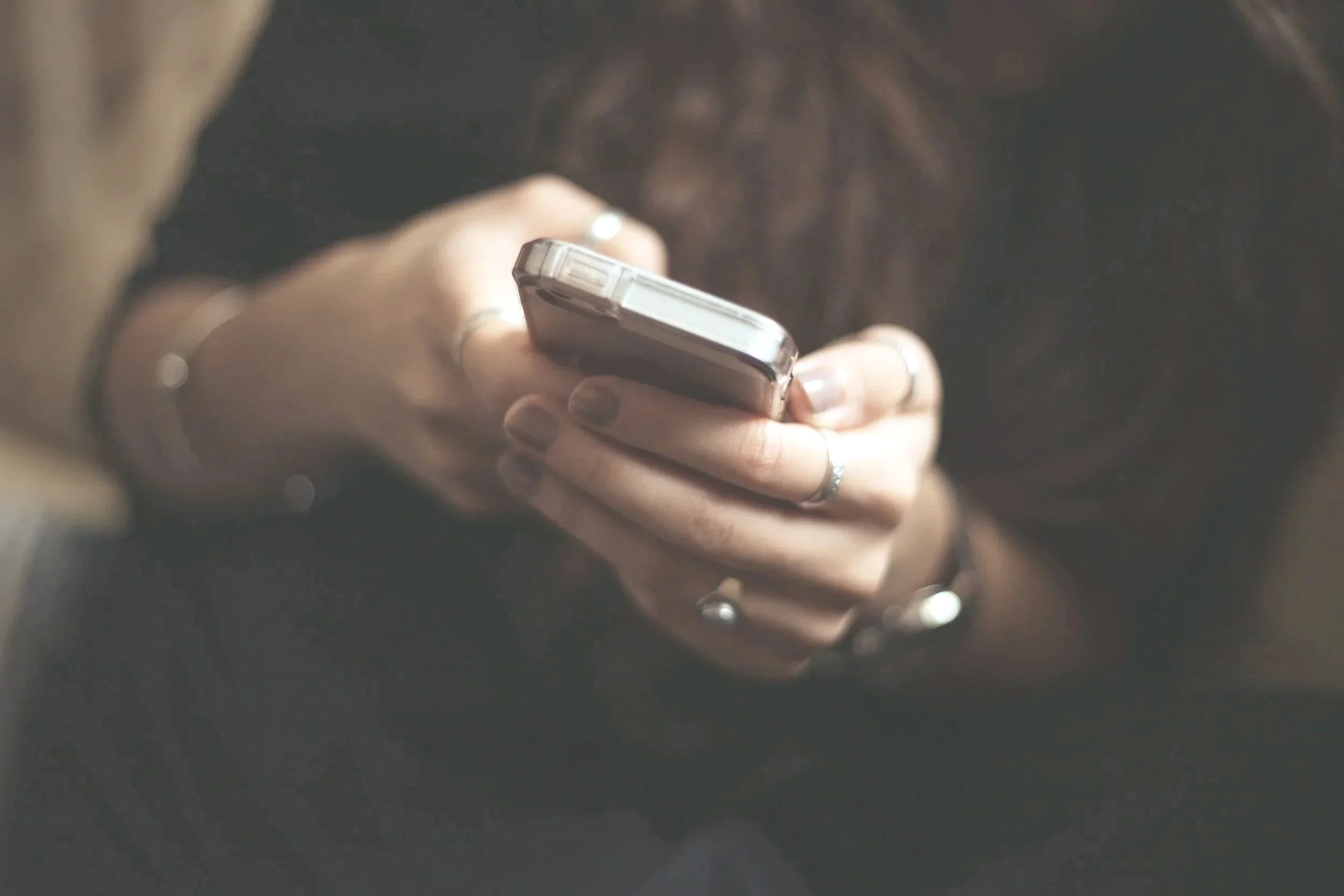 Modern house on grassy hills with snow-capped mountains in background