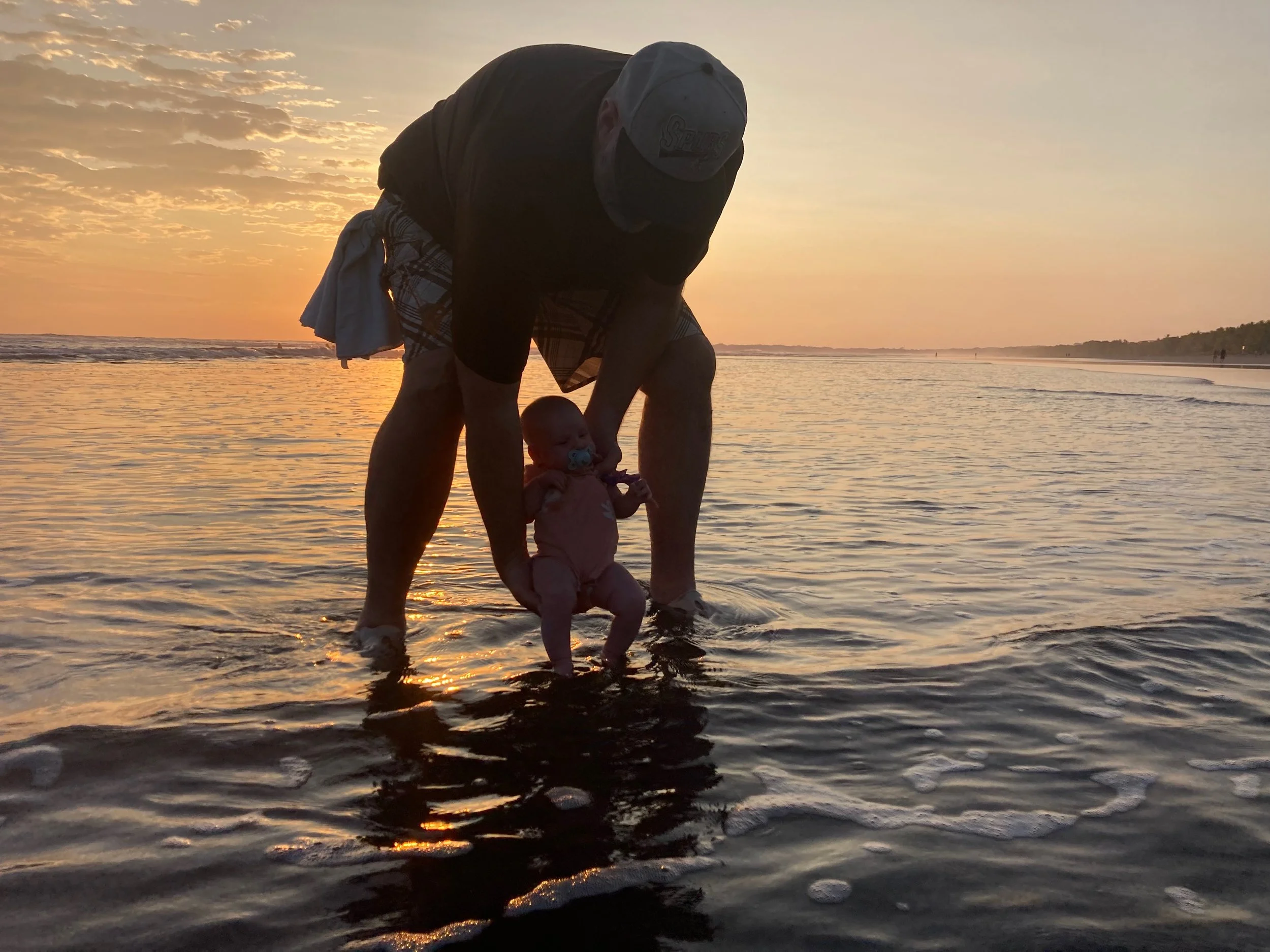 Felicity's first dip in the Pacific Ocean at 6 weeks