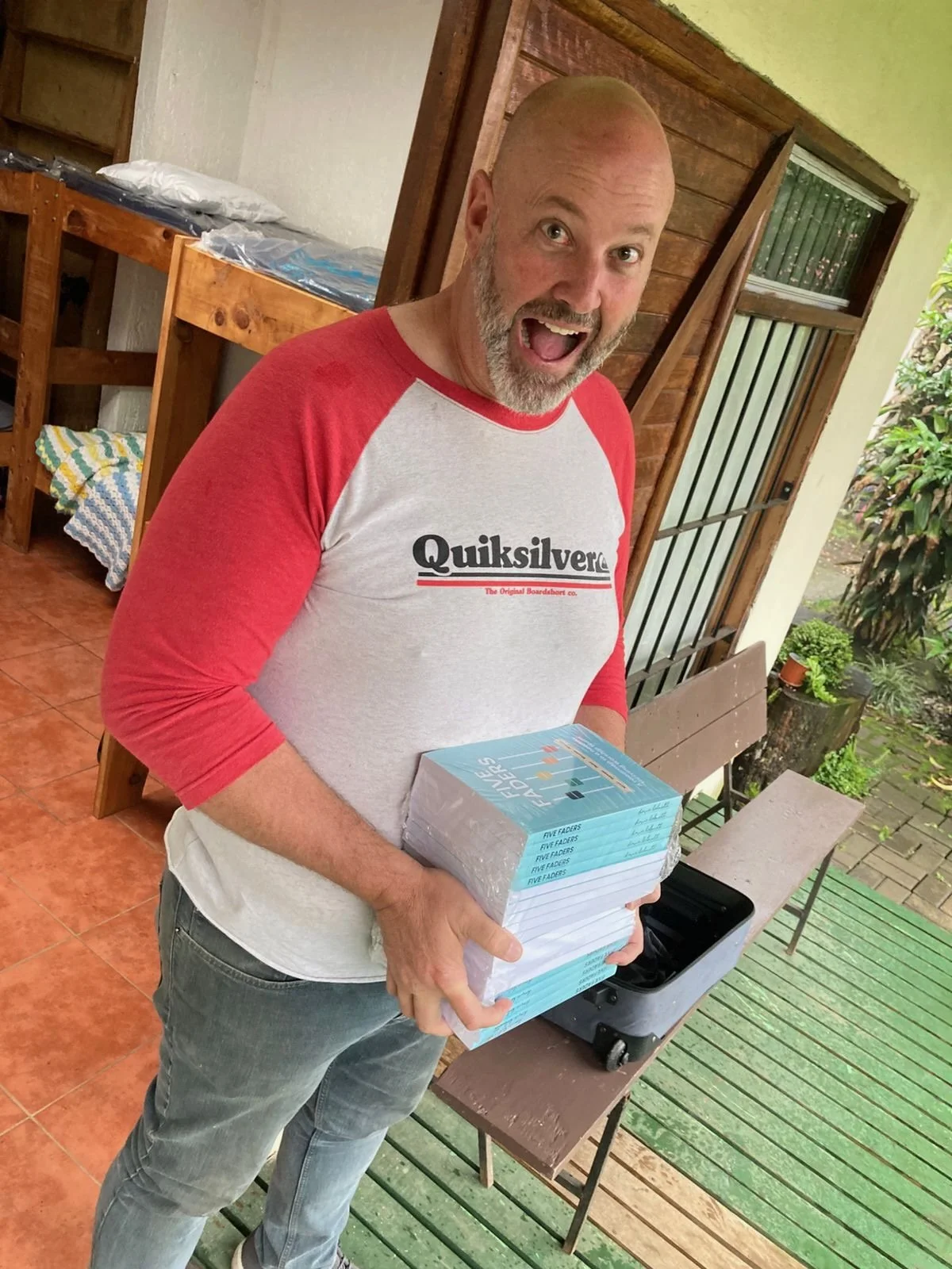 Dave holding physical copies of his Five Faders book