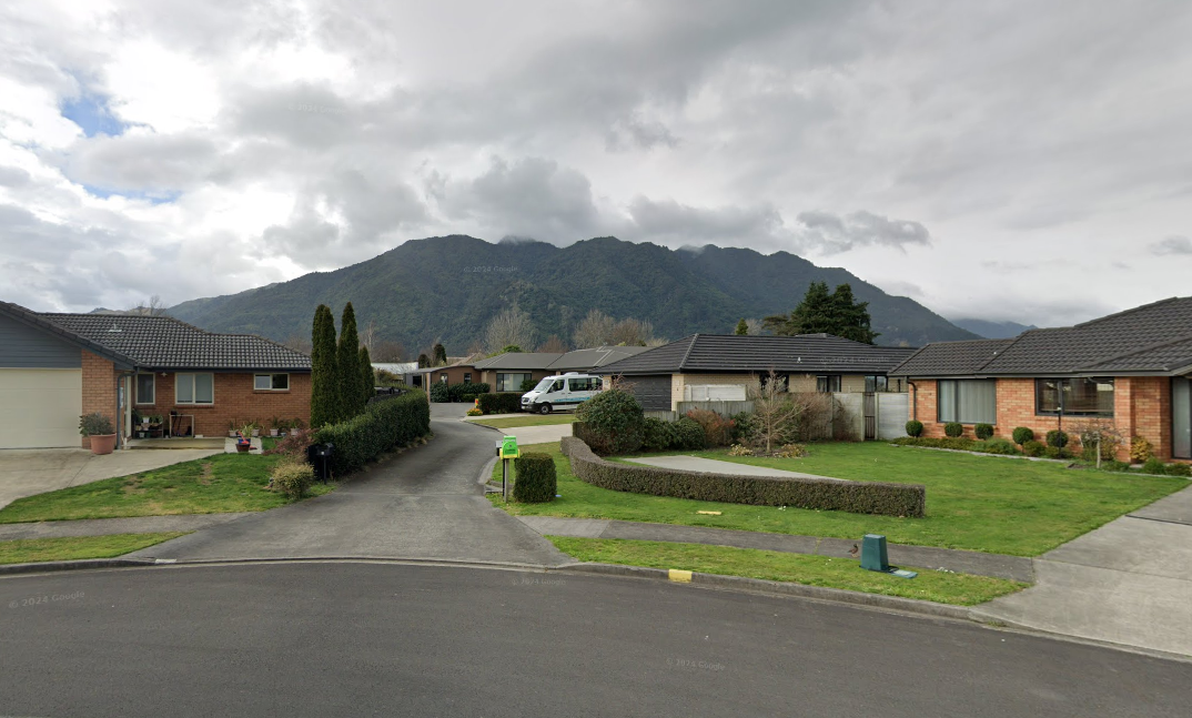 Surveyor on construction site with planning report, Feaver Planning support for builders in NZ