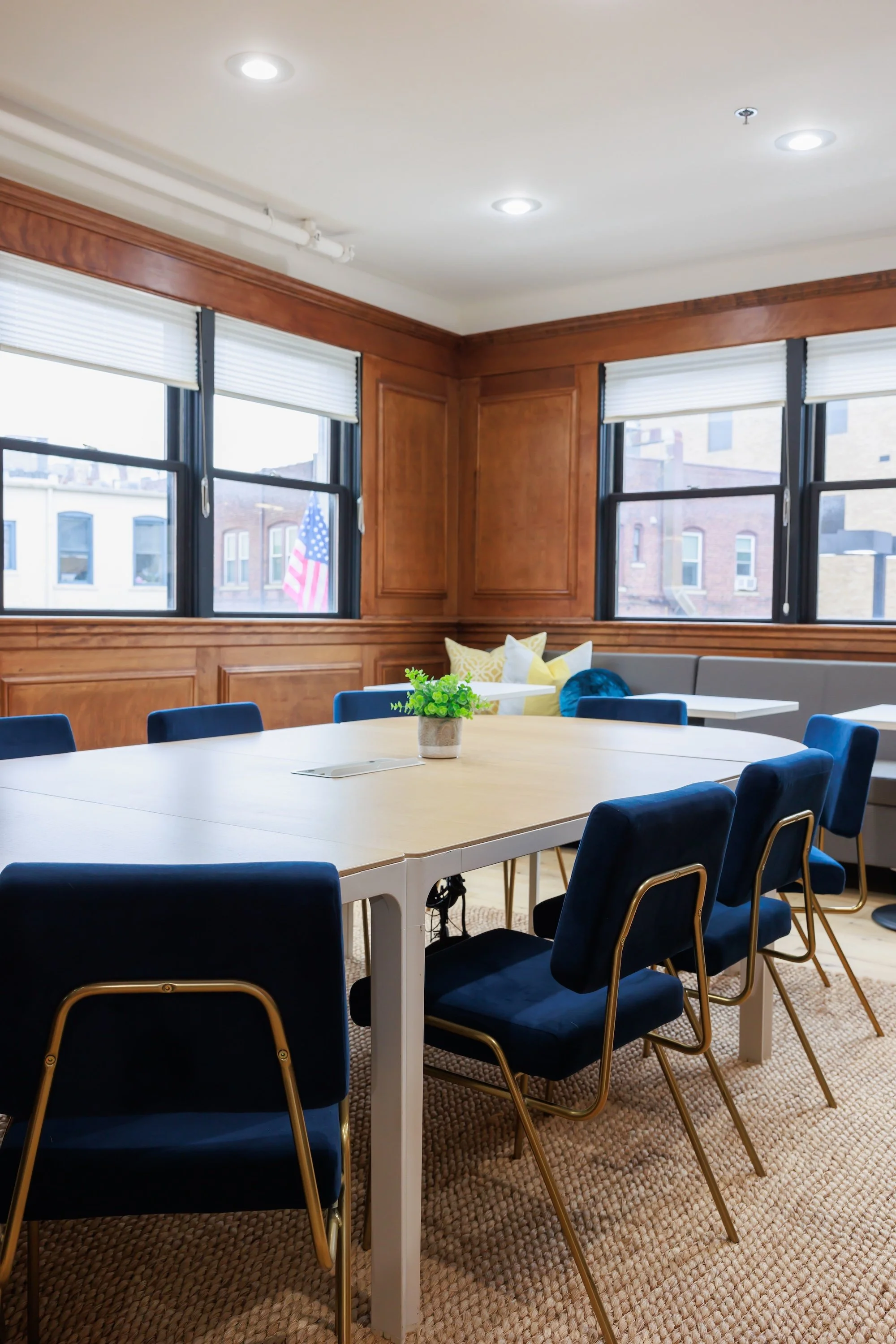 Wood paneled conference room with table and blue chairs