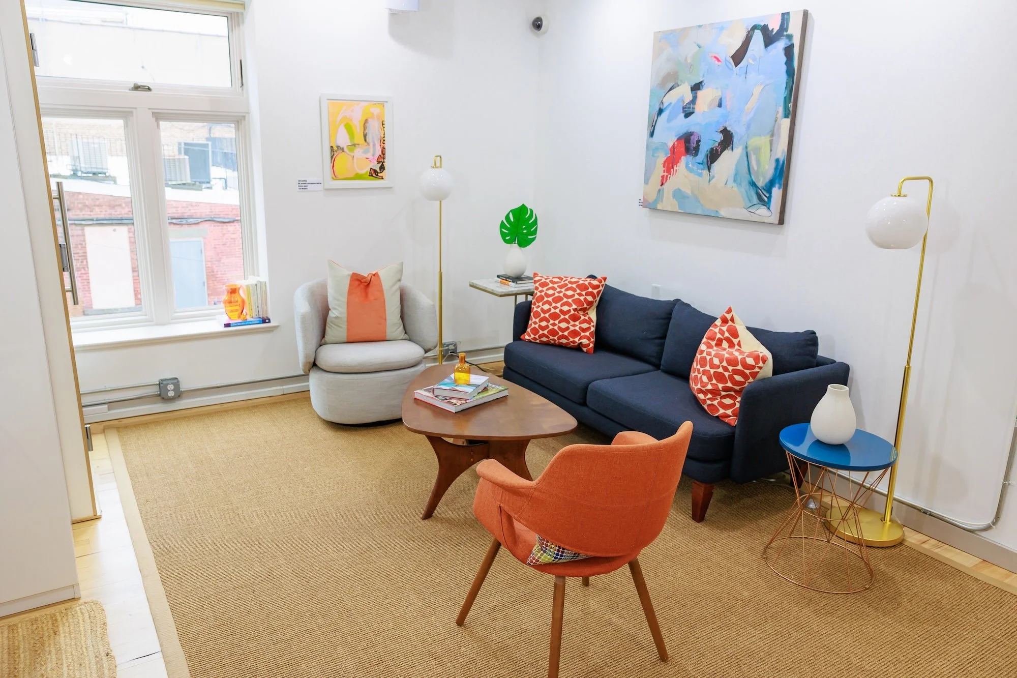 Office lounge area with blue sofa, coffe table and chairs